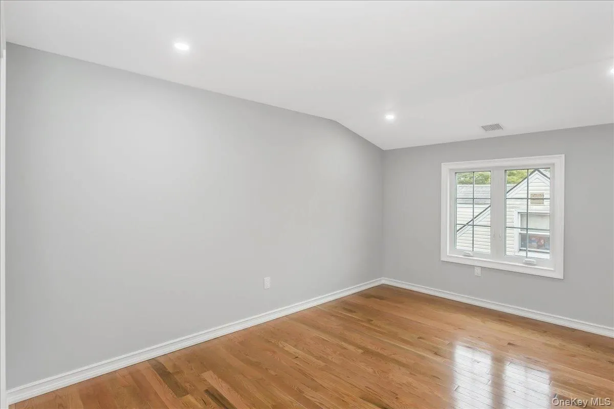 Spare room featuring light wood-type flooring, recessed lighting, and vaulted ceiling Spare room featuring light wood-type flooring, recessed lighting, and vaulted ceiling