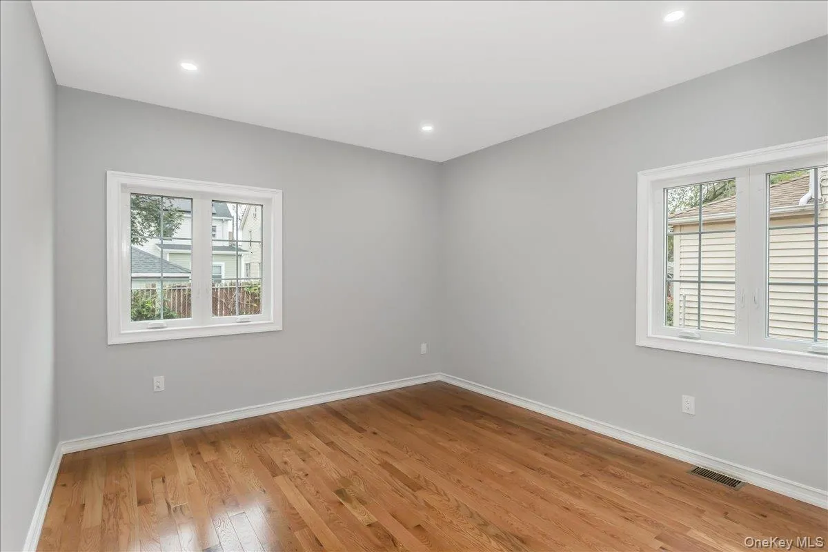 Empty room with light wood-style floors and recessed lighting Empty room with light wood-style floors and recessed lighting