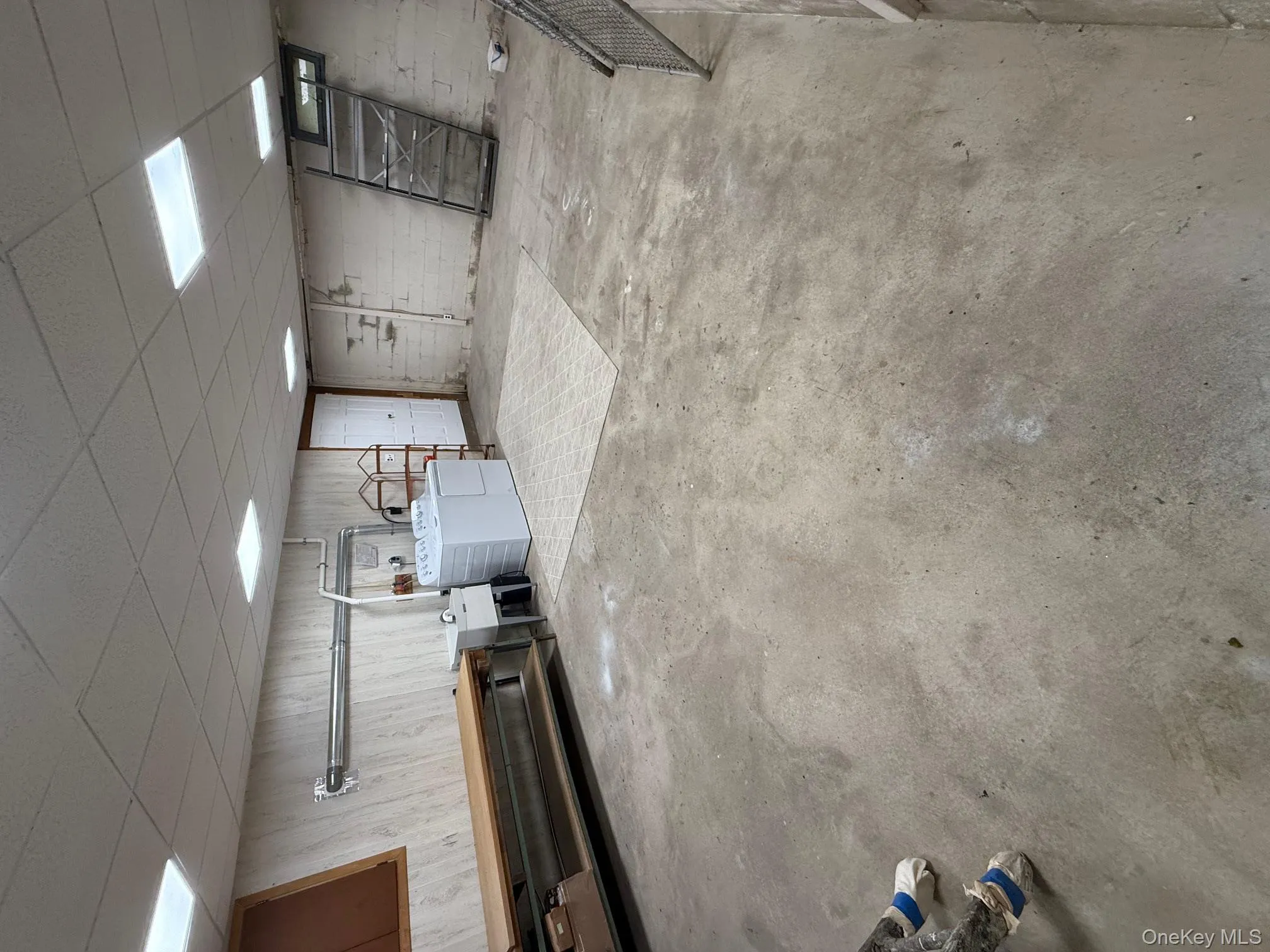 Basement featuring a drop ceiling and washer and dryer Basement featuring a drop ceiling and washer and dryer