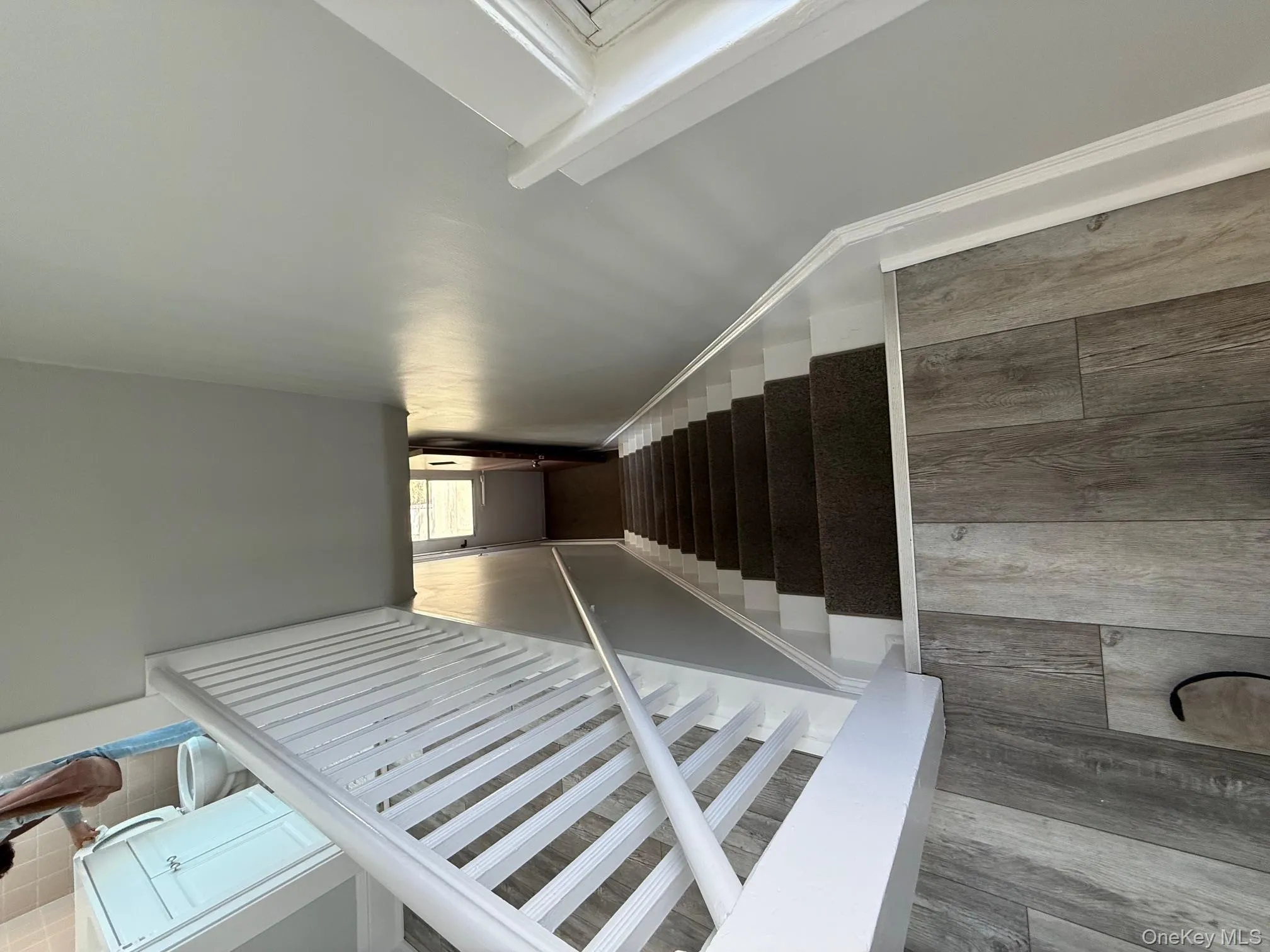 Stairway featuring wood finished floors Stairway featuring wood finished floors