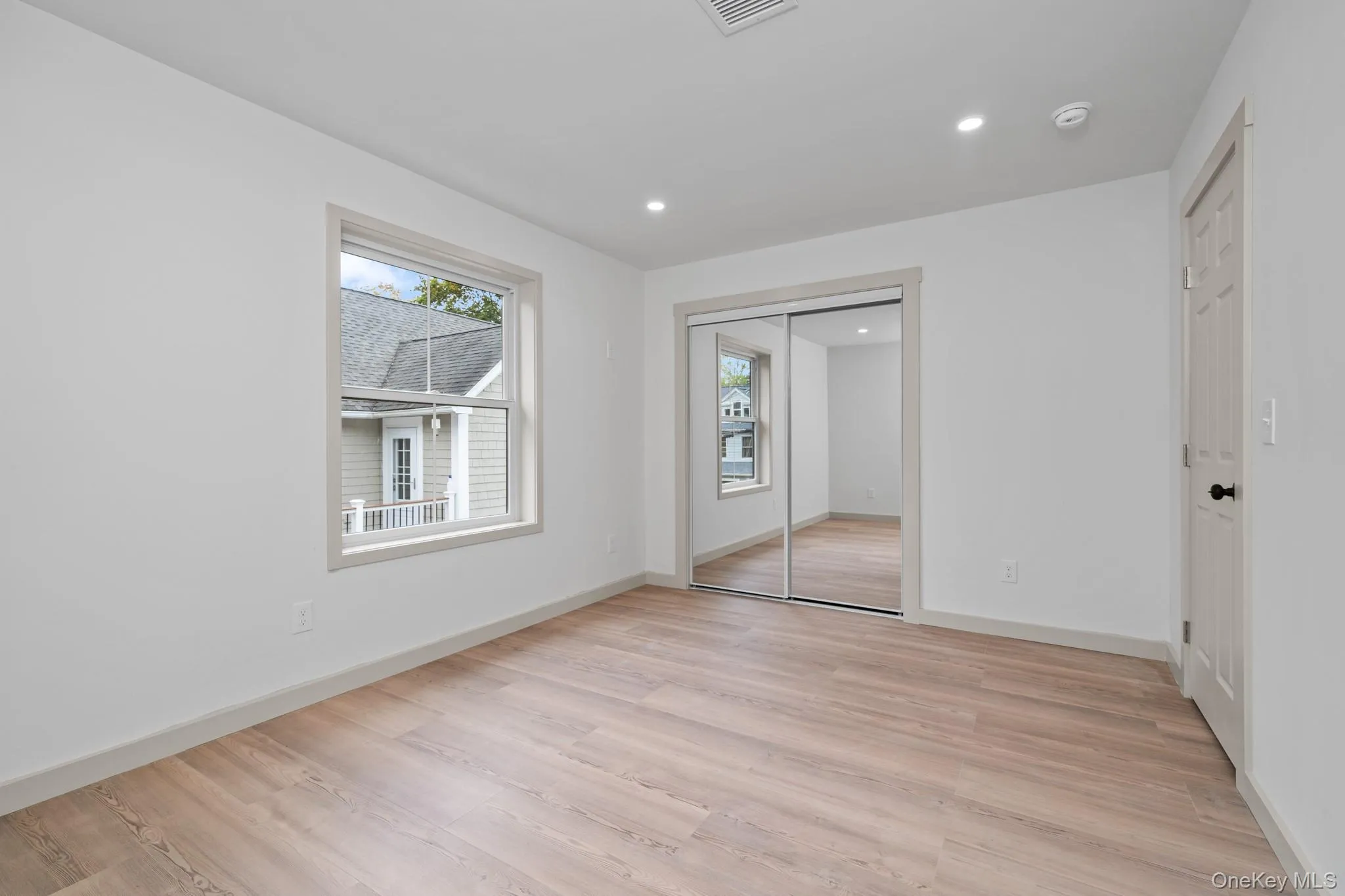 Unfurnished bedroom with light wood-style flooring, recessed lighting, and a closet Unfurnished bedroom with light wood-style flooring, recessed lighting, and a closet