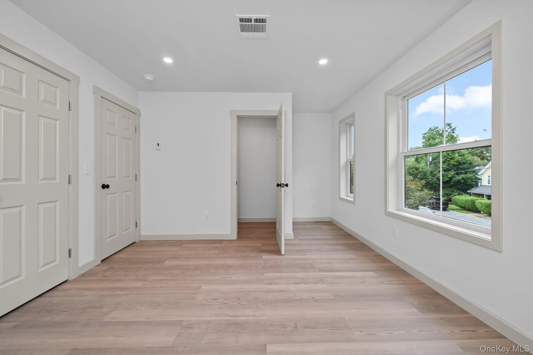Unfurnished bedroom with recessed lighting and light wood-style flooring Unfurnished bedroom with recessed lighting and light wood-style flooring