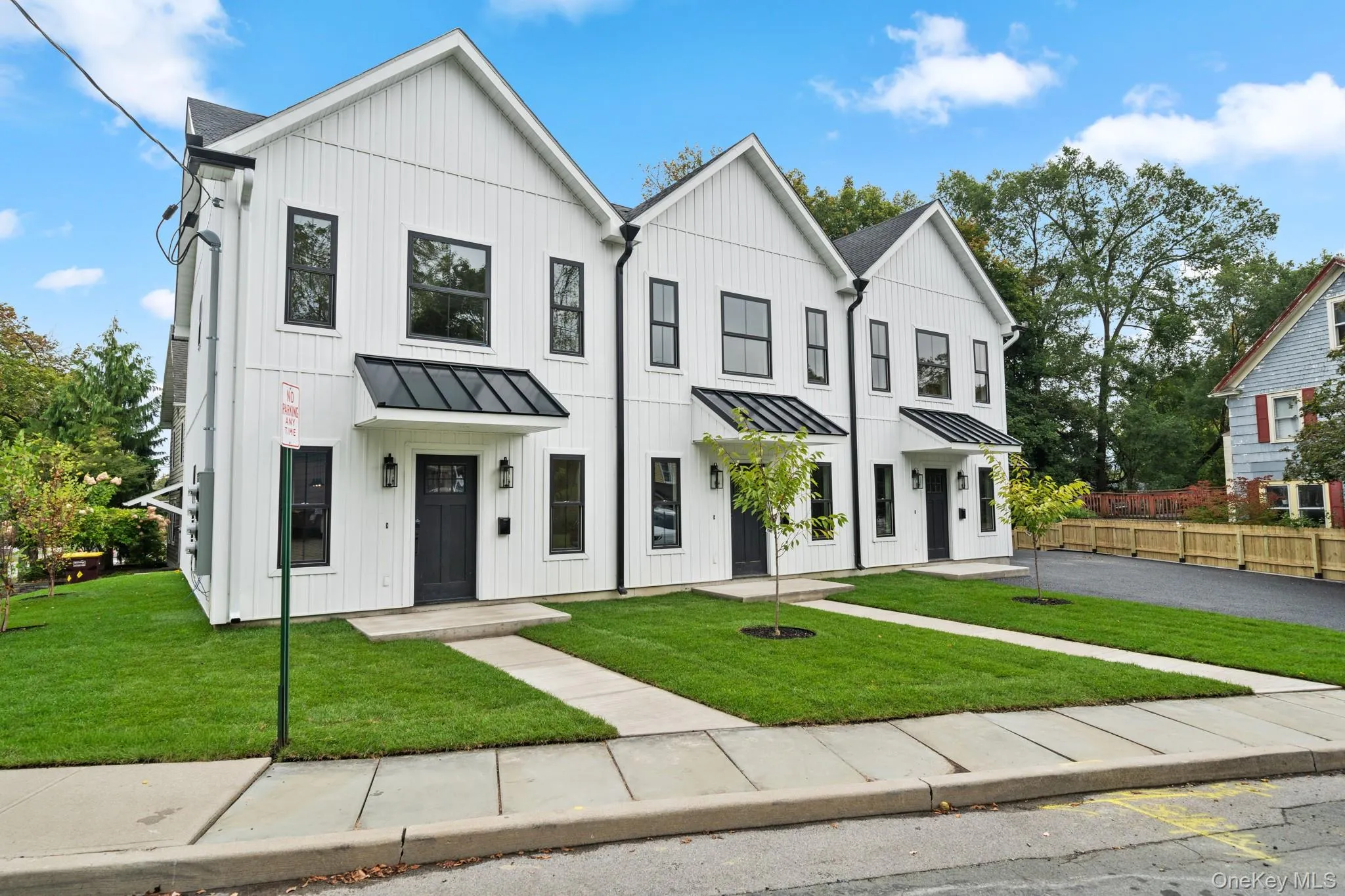 Modern farmhouse style home featuring a standing seam roof, a metal roof, and board and batten siding Modern farmhouse style home featuring a standing seam roof, a metal roof, and board and batten siding