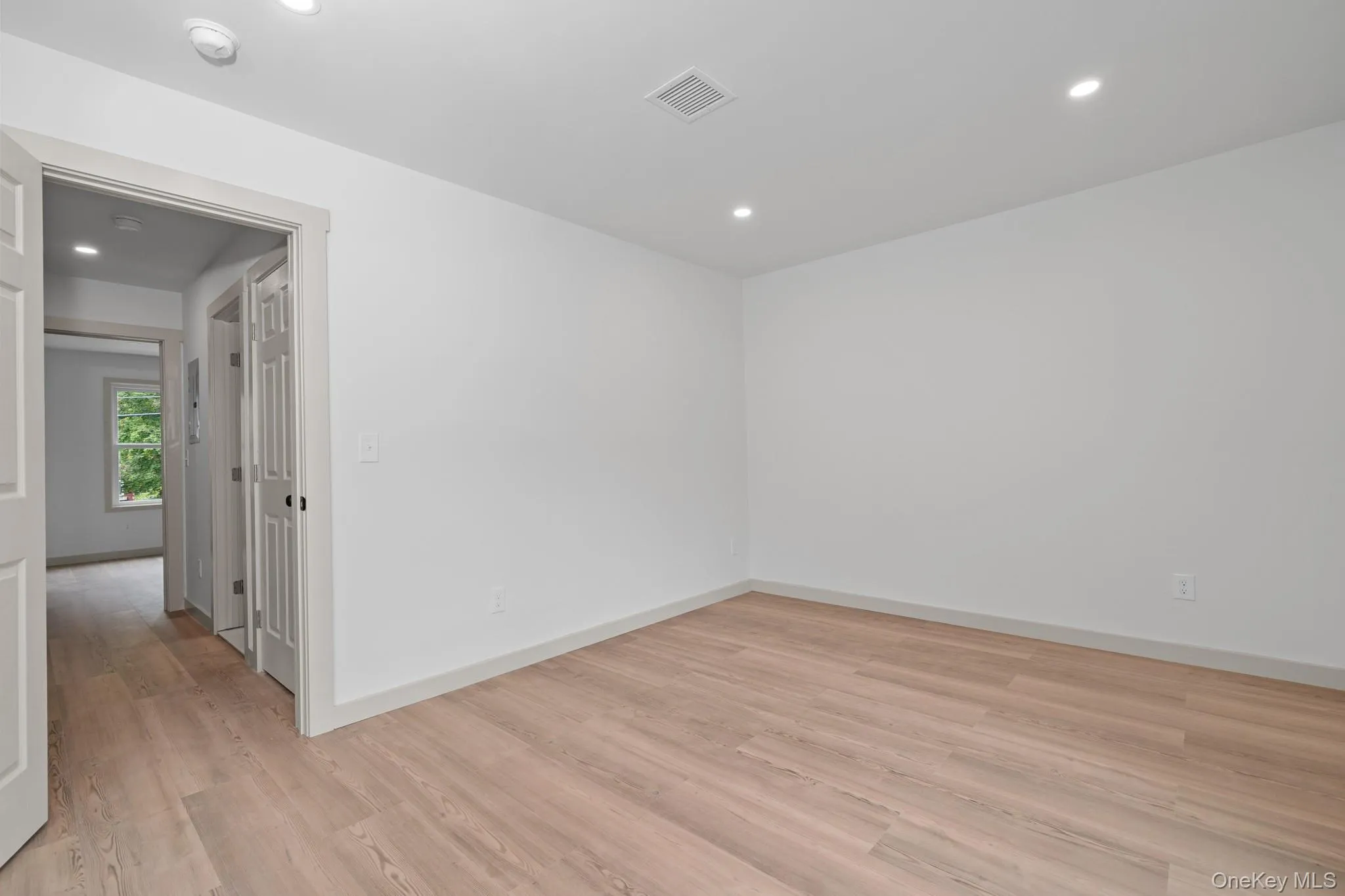 Empty room featuring light wood-type flooring and recessed lighting Empty room featuring light wood-type flooring and recessed lighting