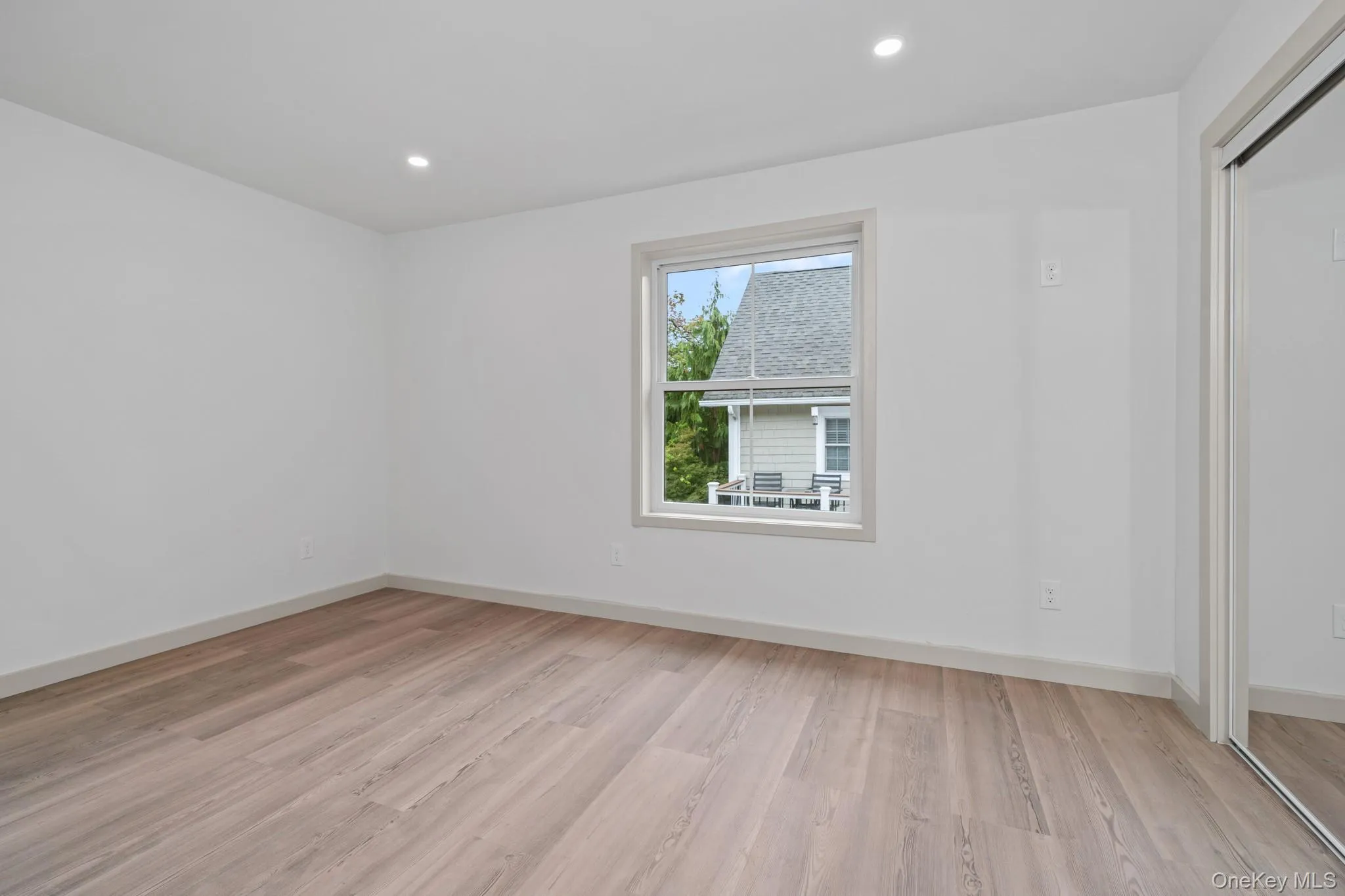 Unfurnished room with light wood-type flooring and recessed lighting Unfurnished room with light wood-type flooring and recessed lighting