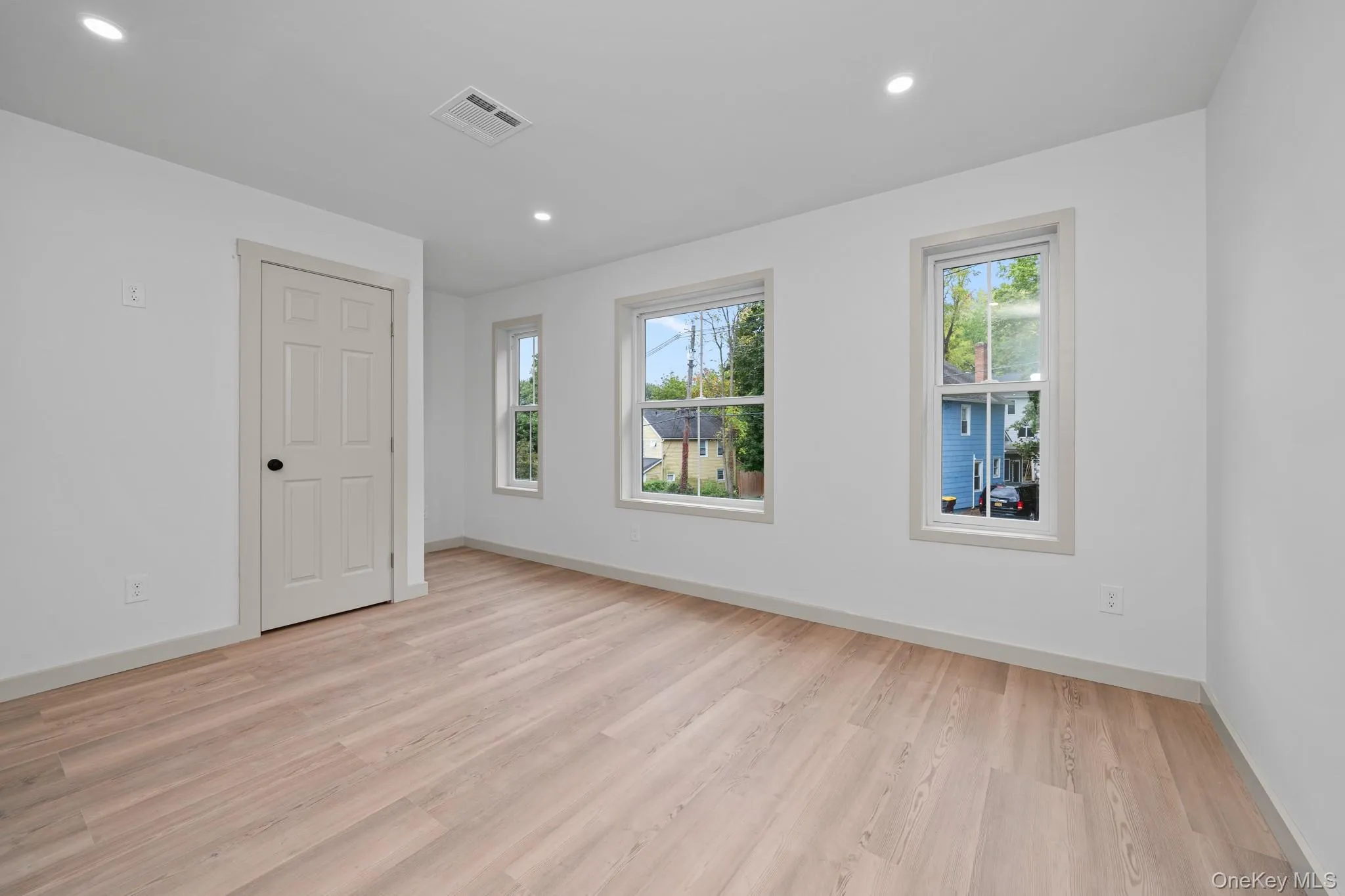 Unfurnished room with light wood-style floors and recessed lighting Unfurnished room with light wood-style floors and recessed lighting