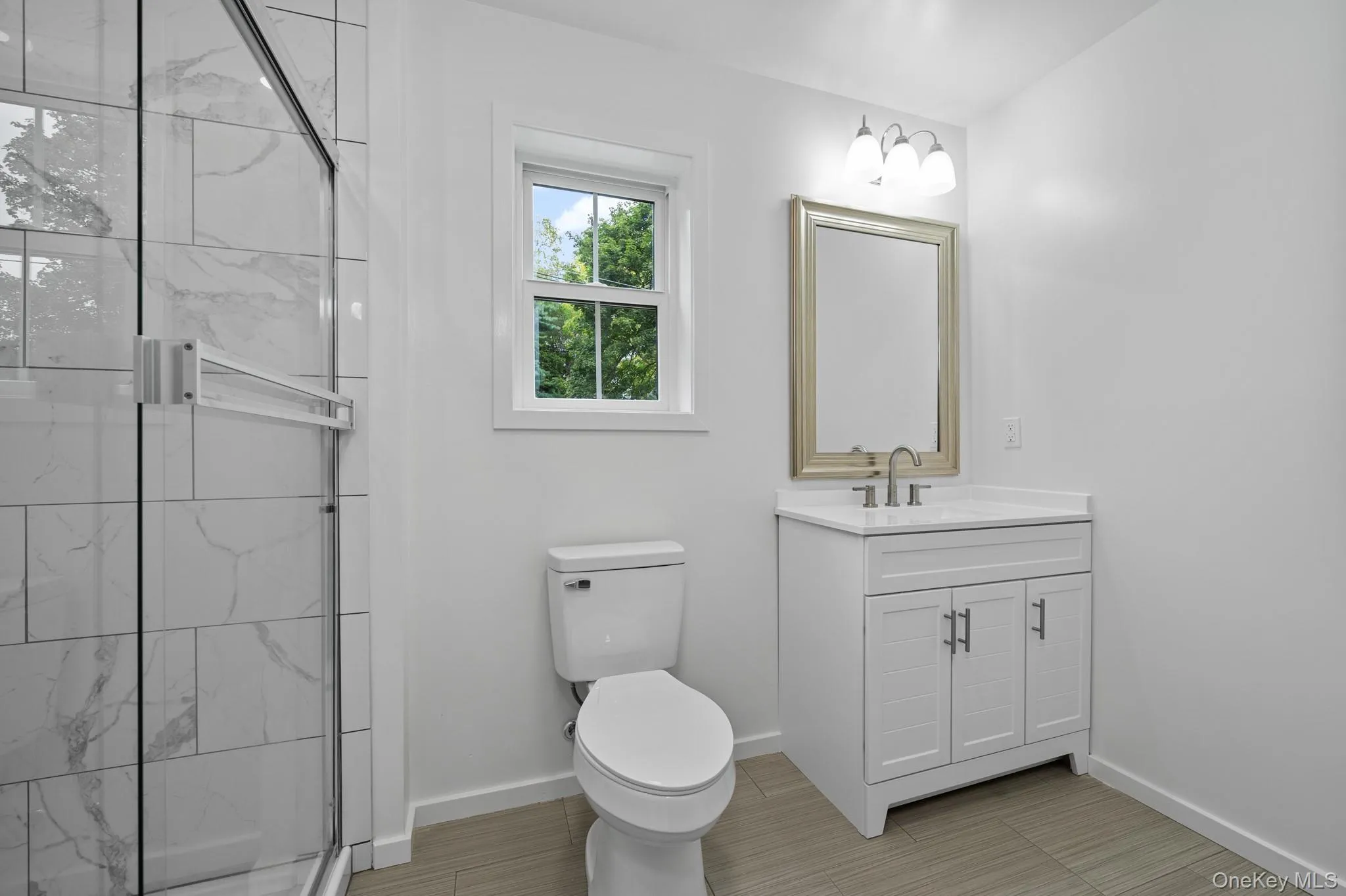 Full bath with a marble finish shower and vanity Full bath with a marble finish shower and vanity