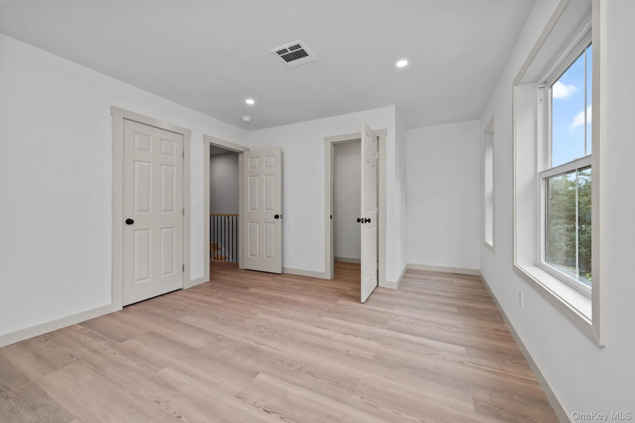 Unfurnished bedroom featuring recessed lighting and light wood finished floors Unfurnished bedroom featuring recessed lighting and light wood finished floors