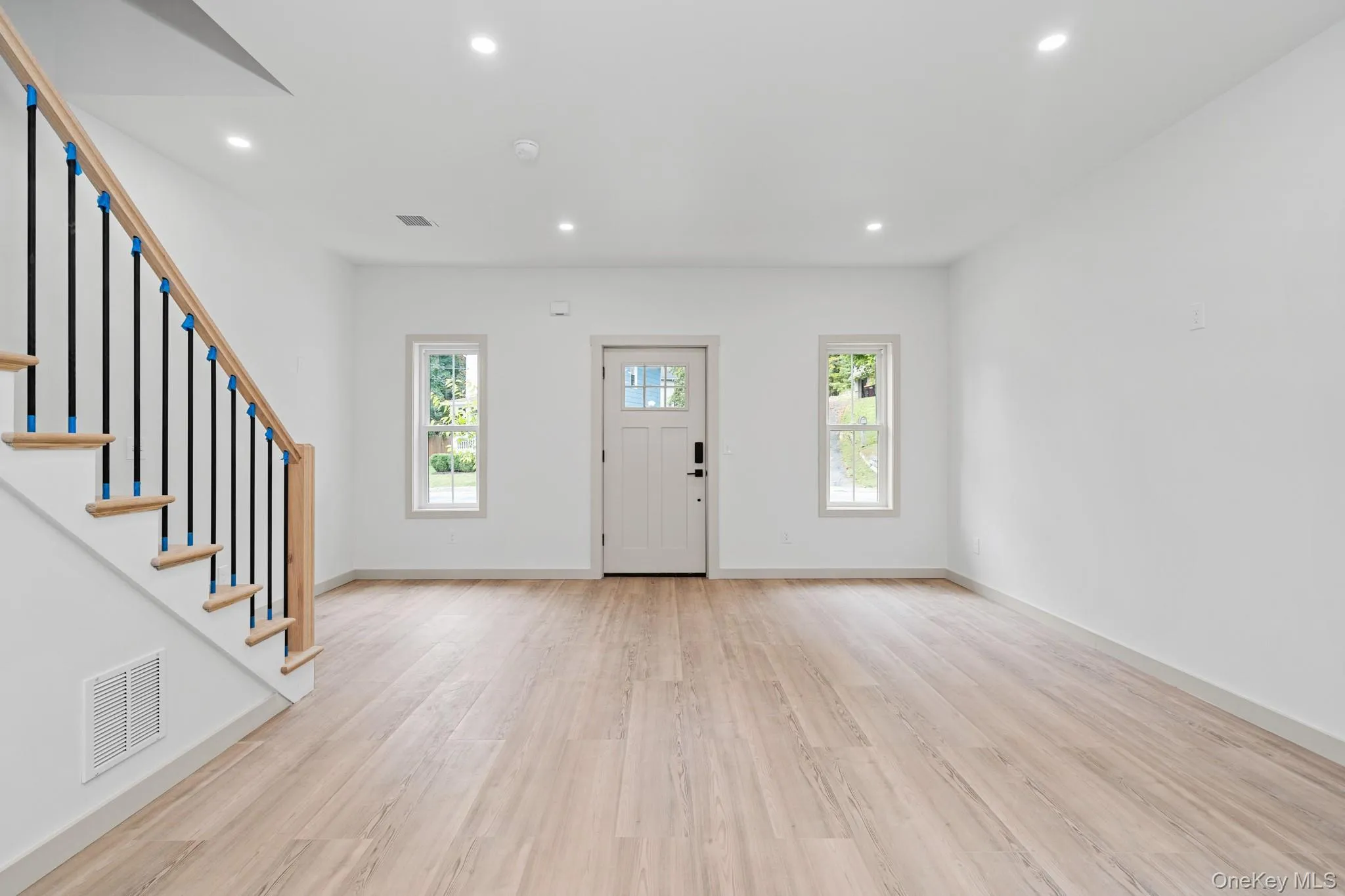 Entryway featuring recessed lighting, light wood-type flooring, and stairs Entryway featuring recessed lighting, light wood-type flooring, and stairs