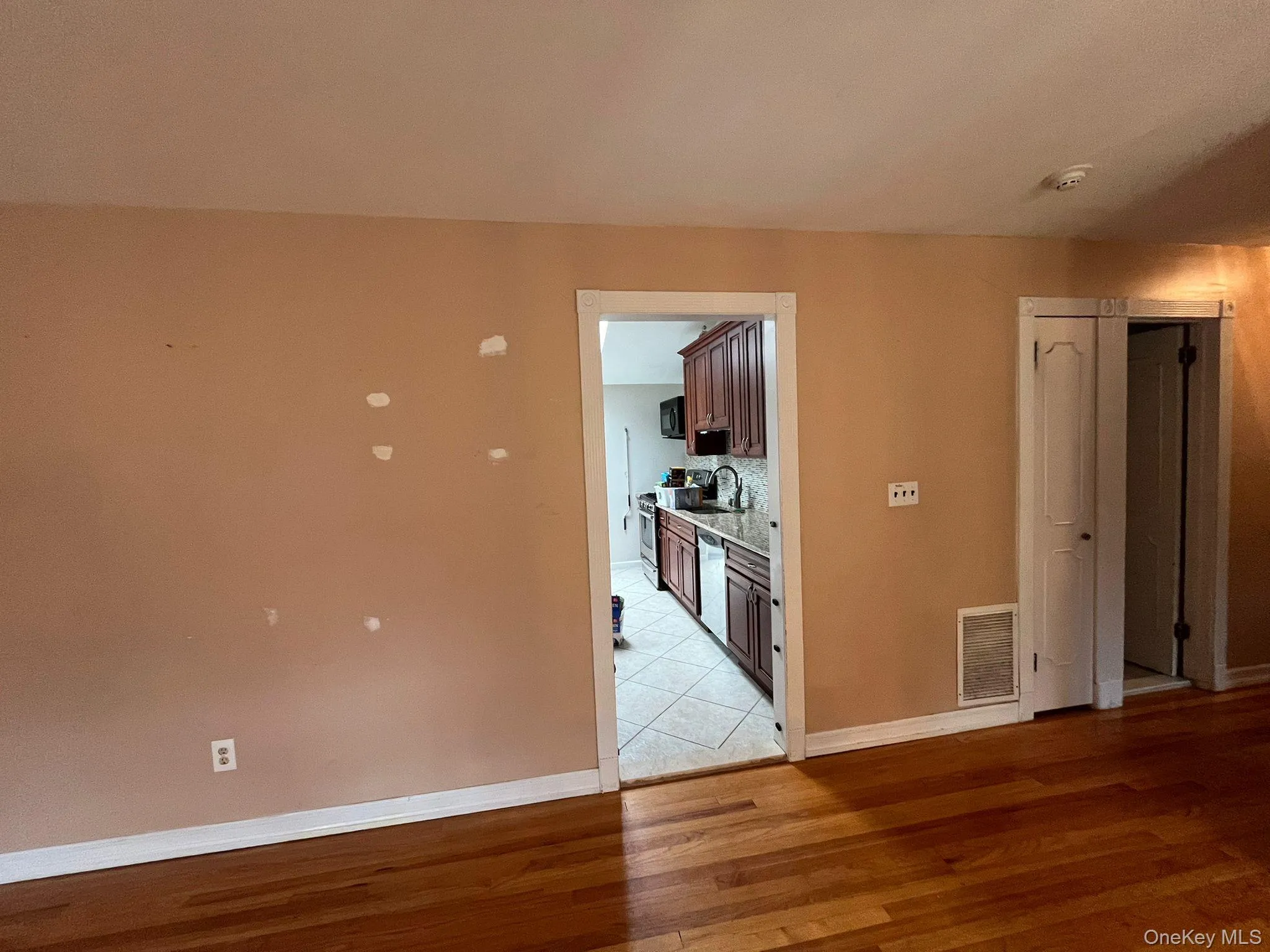 Spare room with light wood finished floors and baseboards Spare room with light wood finished floors and baseboards