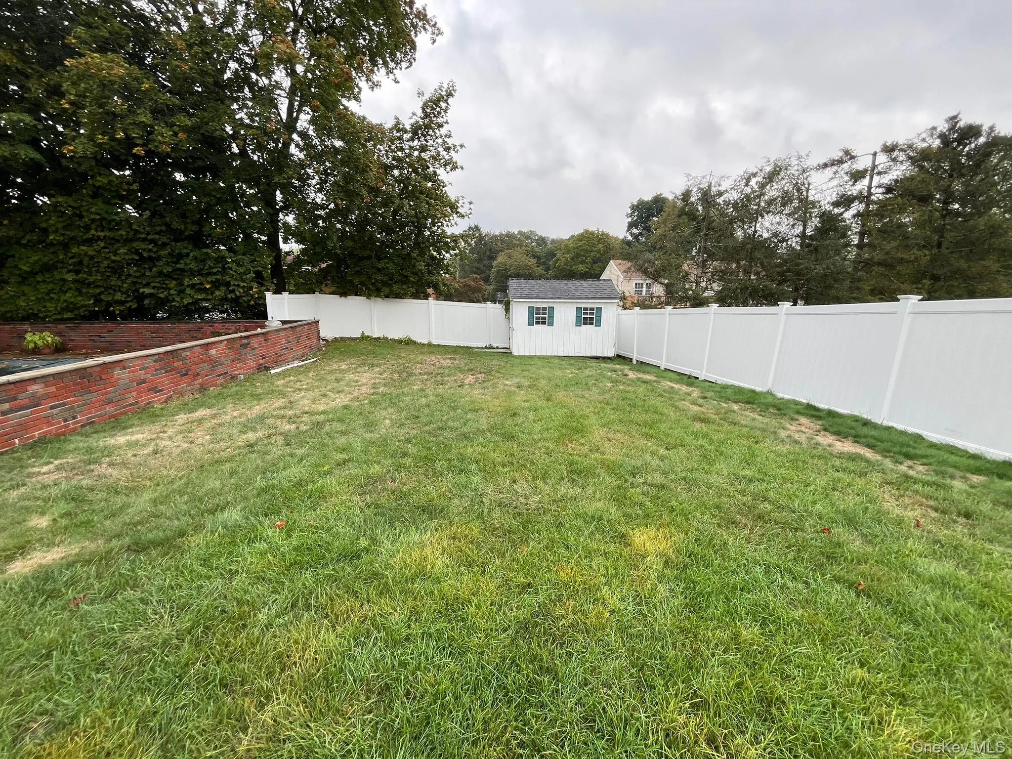 Fenced backyard with a shed Fenced backyard with a shed