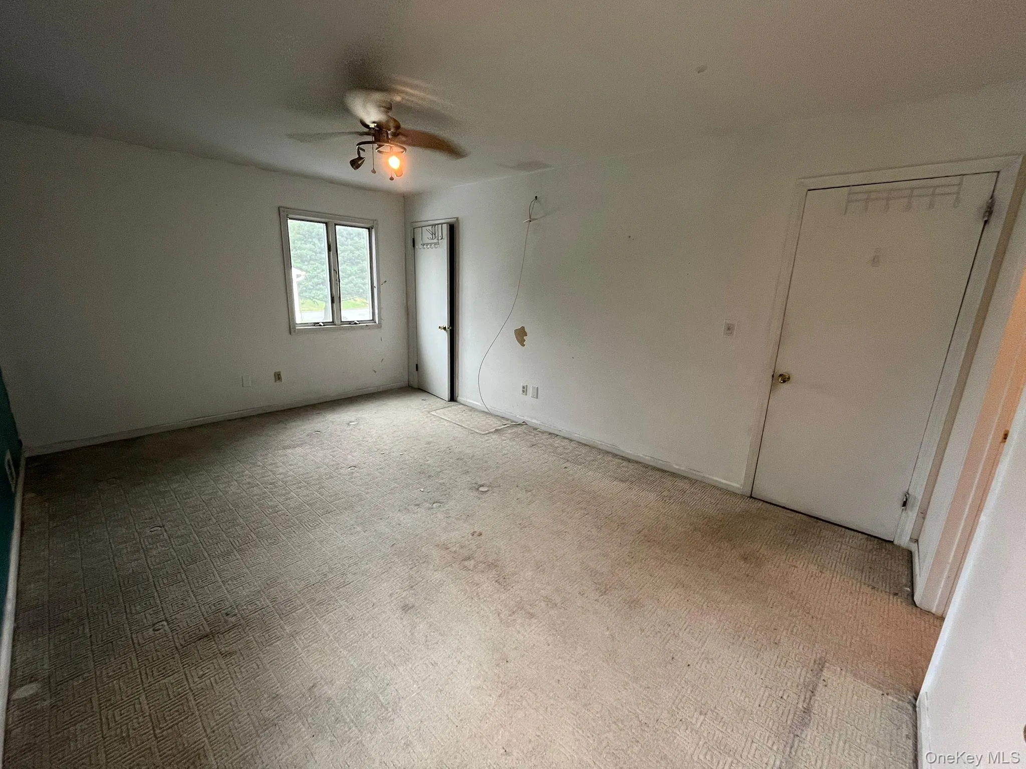 Unfurnished bedroom featuring carpet floors and a ceiling fan Unfurnished bedroom featuring carpet floors and a ceiling fan