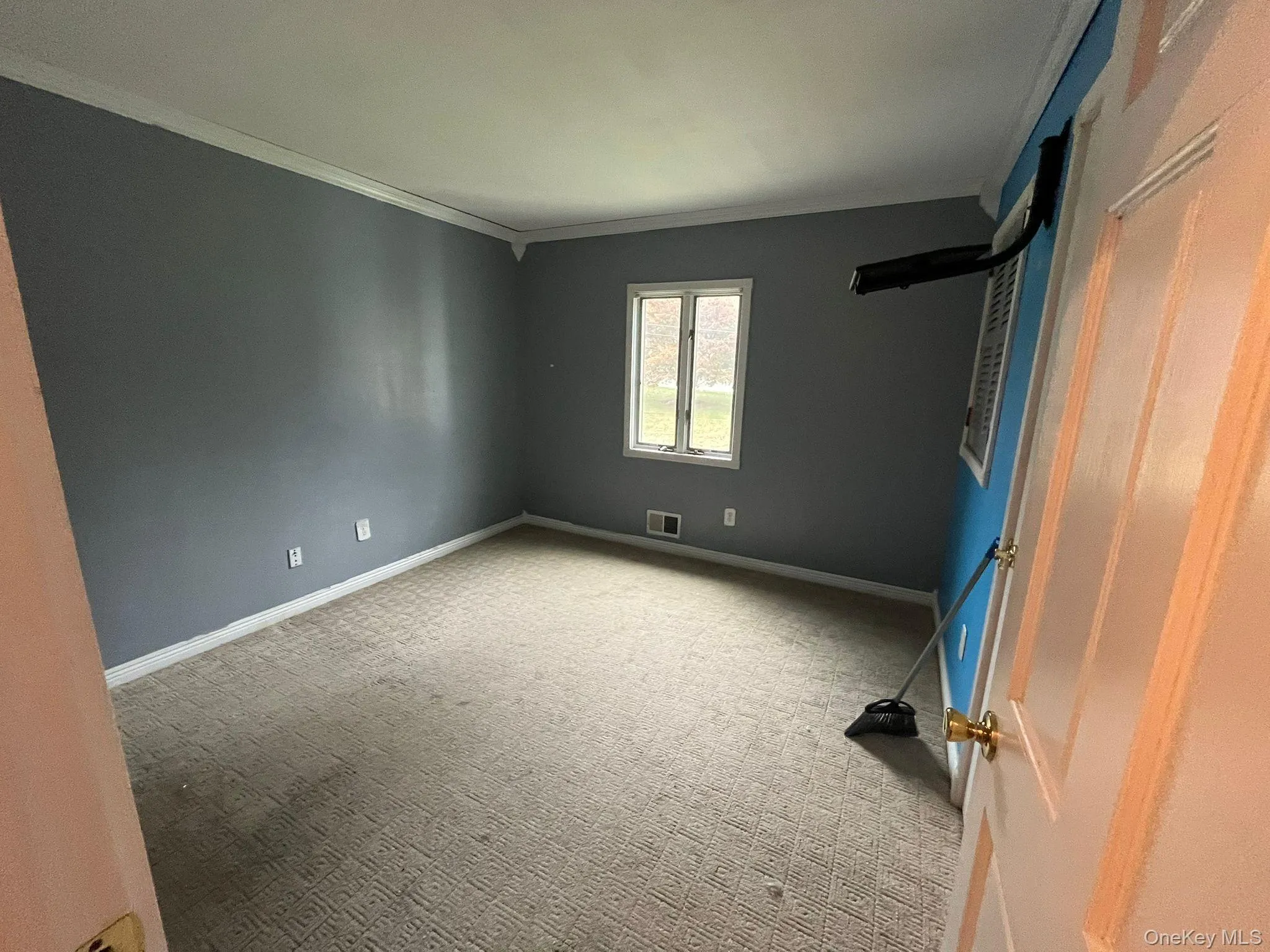 Unfurnished bedroom with light colored carpet and crown molding Unfurnished bedroom with light colored carpet and crown molding