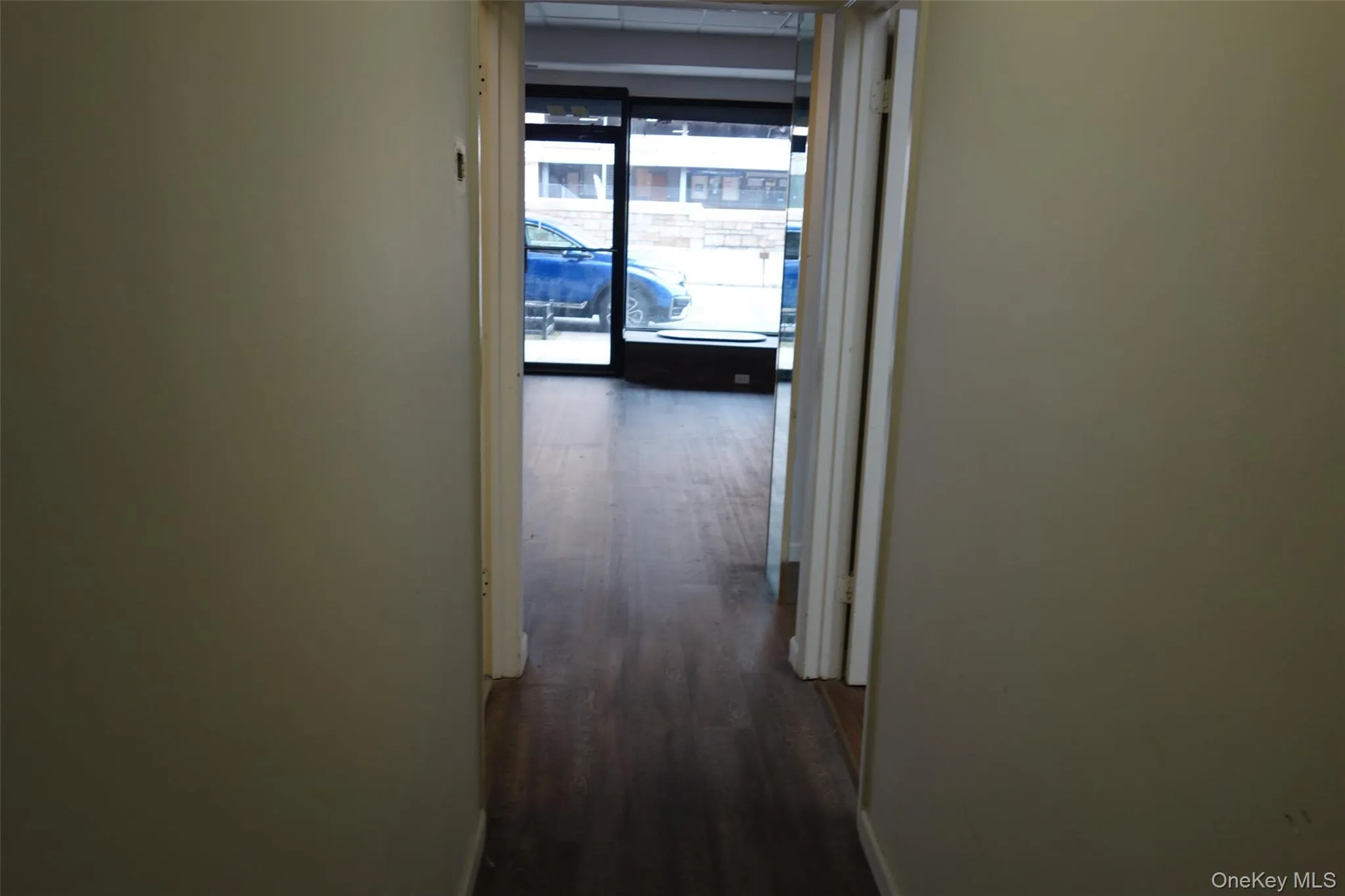 Corridor featuring dark wood-type flooring Corridor featuring dark wood-type flooring