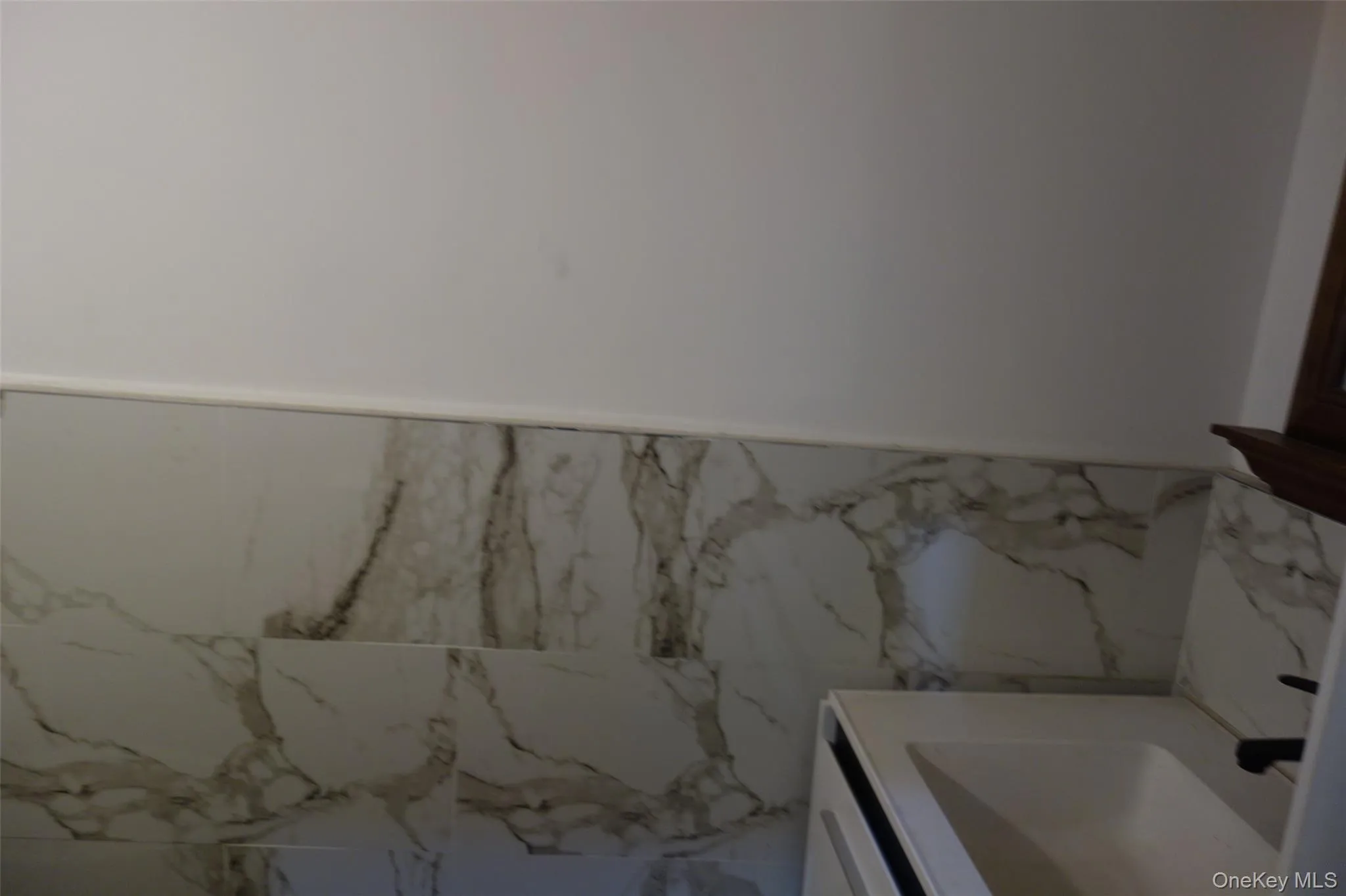 Bathroom with a wainscoted wall, tile walls, and vanity Bathroom with a wainscoted wall, tile walls, and vanity