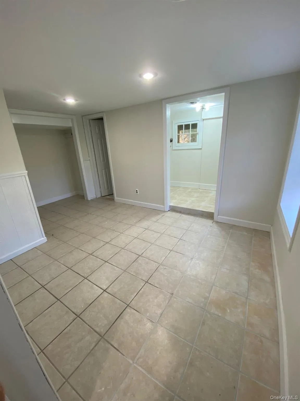 Unfurnished bedroom with light tile patterned flooring Unfurnished bedroom with light tile patterned flooring