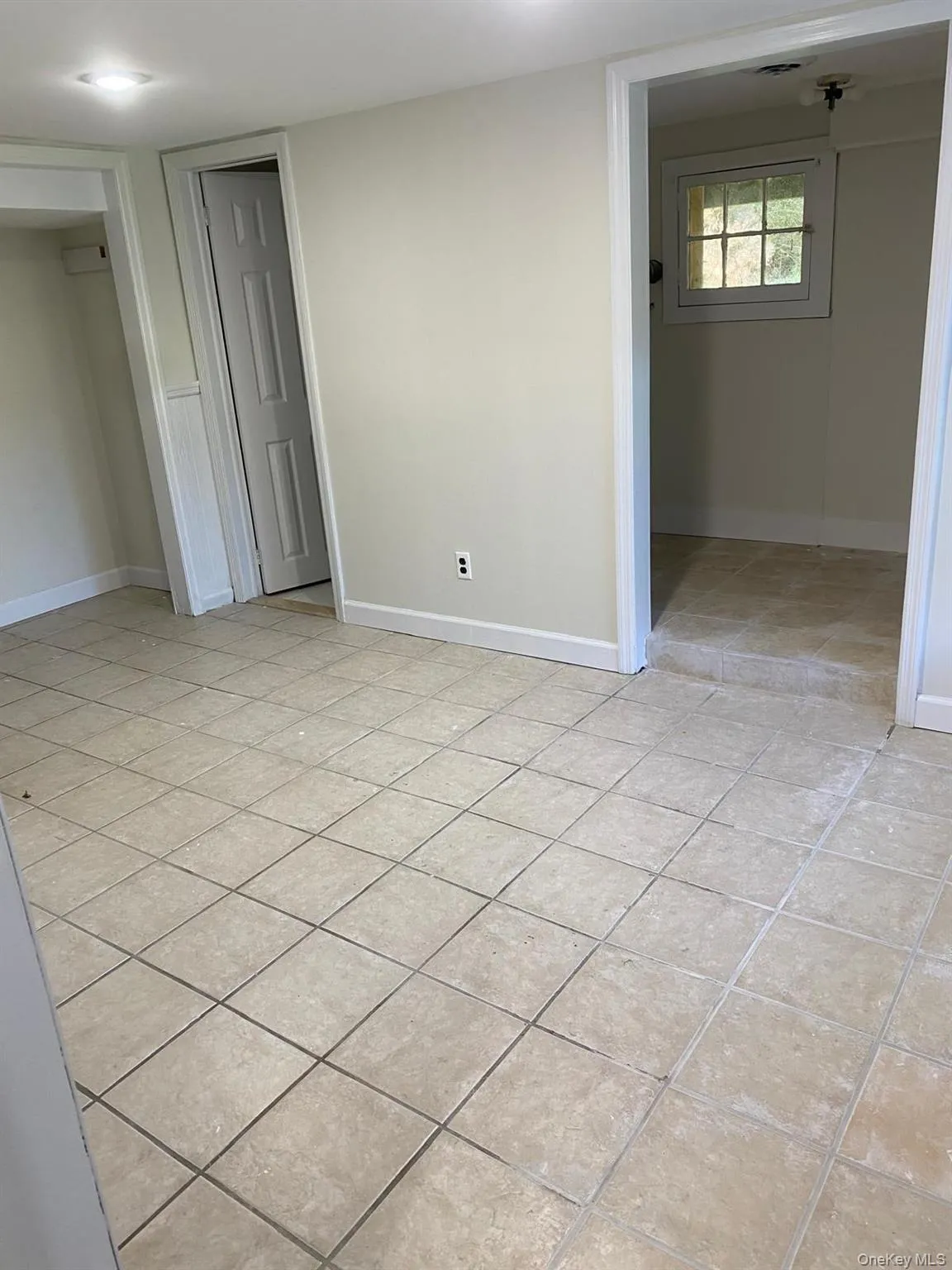 Unfurnished bedroom featuring light tile patterned floors and a closet Unfurnished bedroom featuring light tile patterned floors and a closet
