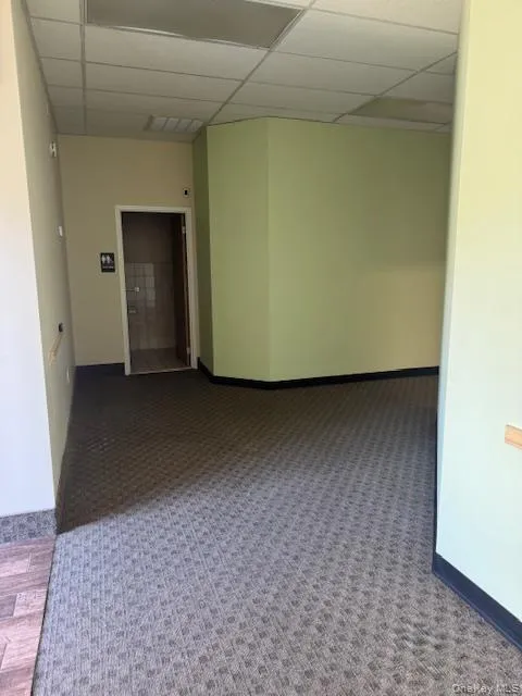 Empty room with a paneled ceiling Empty room with a paneled ceiling