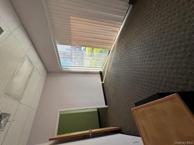 Spare room with a paneled ceiling and dark colored carpet Spare room with a paneled ceiling and dark colored carpet