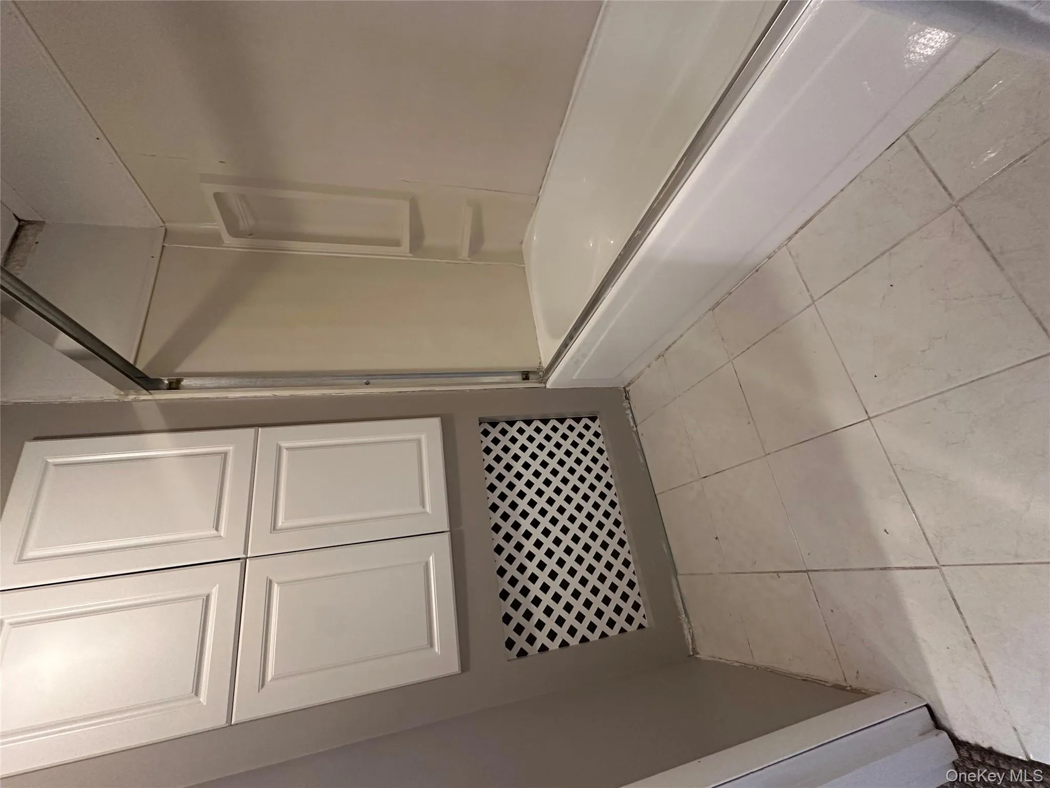 Full bathroom featuring light tile patterned floors and  shower combination Full bathroom featuring light tile patterned floors and  shower combination