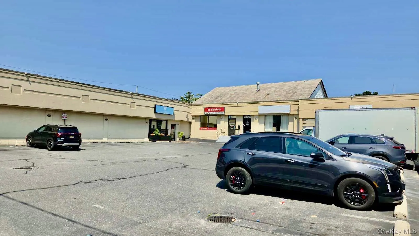 View of commercial property featuring uncovered parking View of commercial property featuring uncovered parking