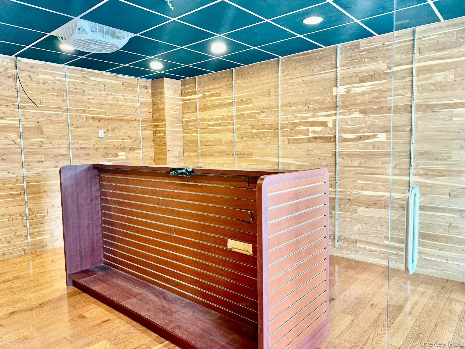 Reception with wooden walls and recessed lighting Reception with wooden walls and recessed lighting