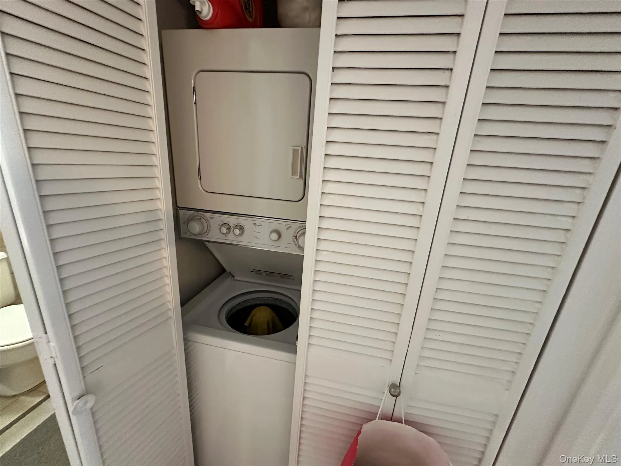 Laundry area featuring stacked washing machine and dryer Laundry area featuring stacked washing machine and dryer