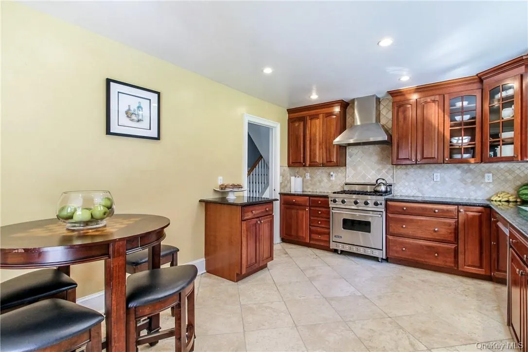 eat-in-kitchen with stainless-steel appliances, granite counters, and ample cabinet storage eat-in-kitchen with stainless-steel appliances, granite counters, and ample cabinet storage