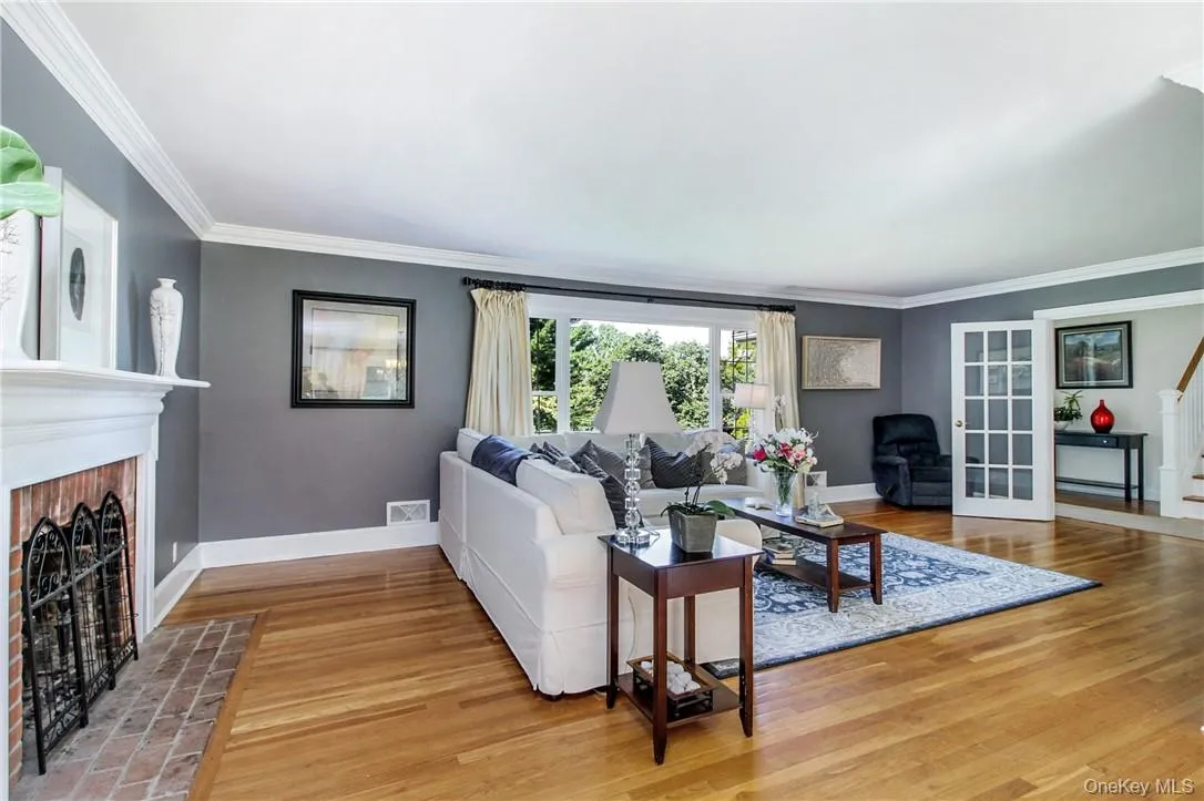 Hardwood floors, wood-burning fireplace and crown molding Hardwood floors, wood-burning fireplace and crown molding