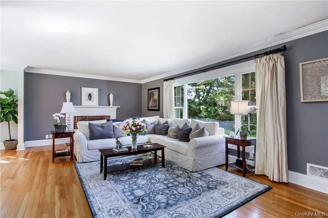 Hardwood floors, wood-burning fireplace and crown molding Hardwood floors, wood-burning fireplace and crown molding