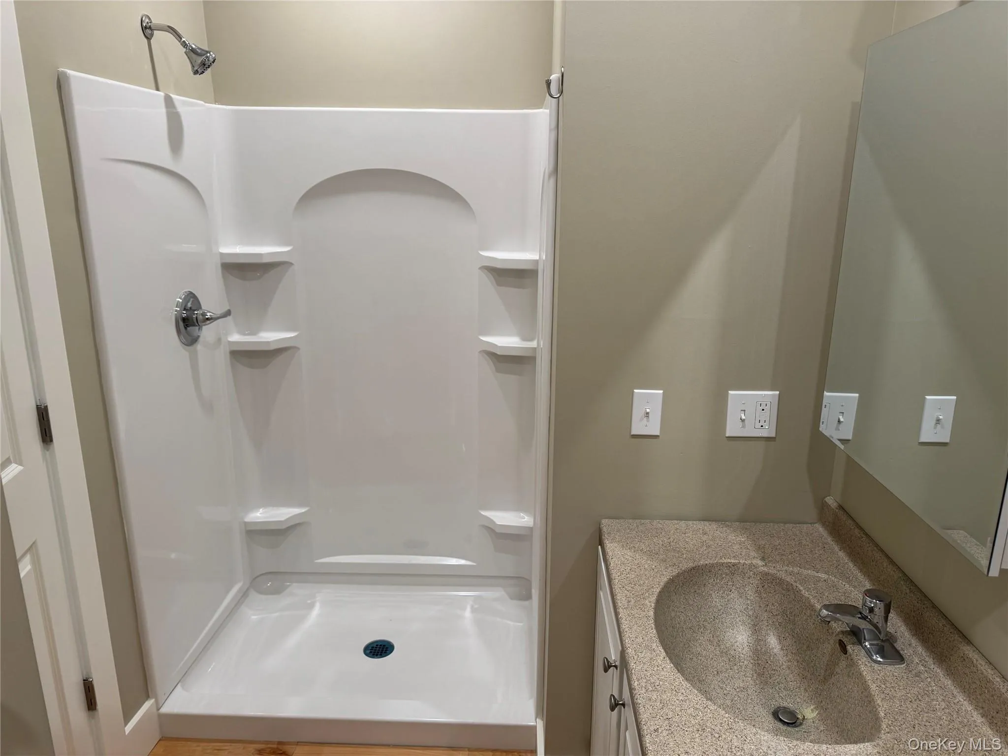 Full bath with a shower stall and vanity Full bath with a shower stall and vanity