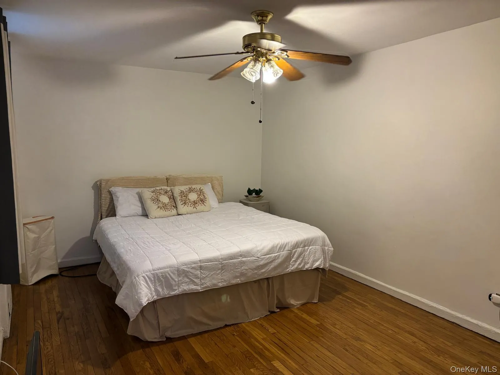 Bedroom featuring dark wood-type flooring and a ceiling fan Bedroom featuring dark wood-type flooring and a ceiling fan