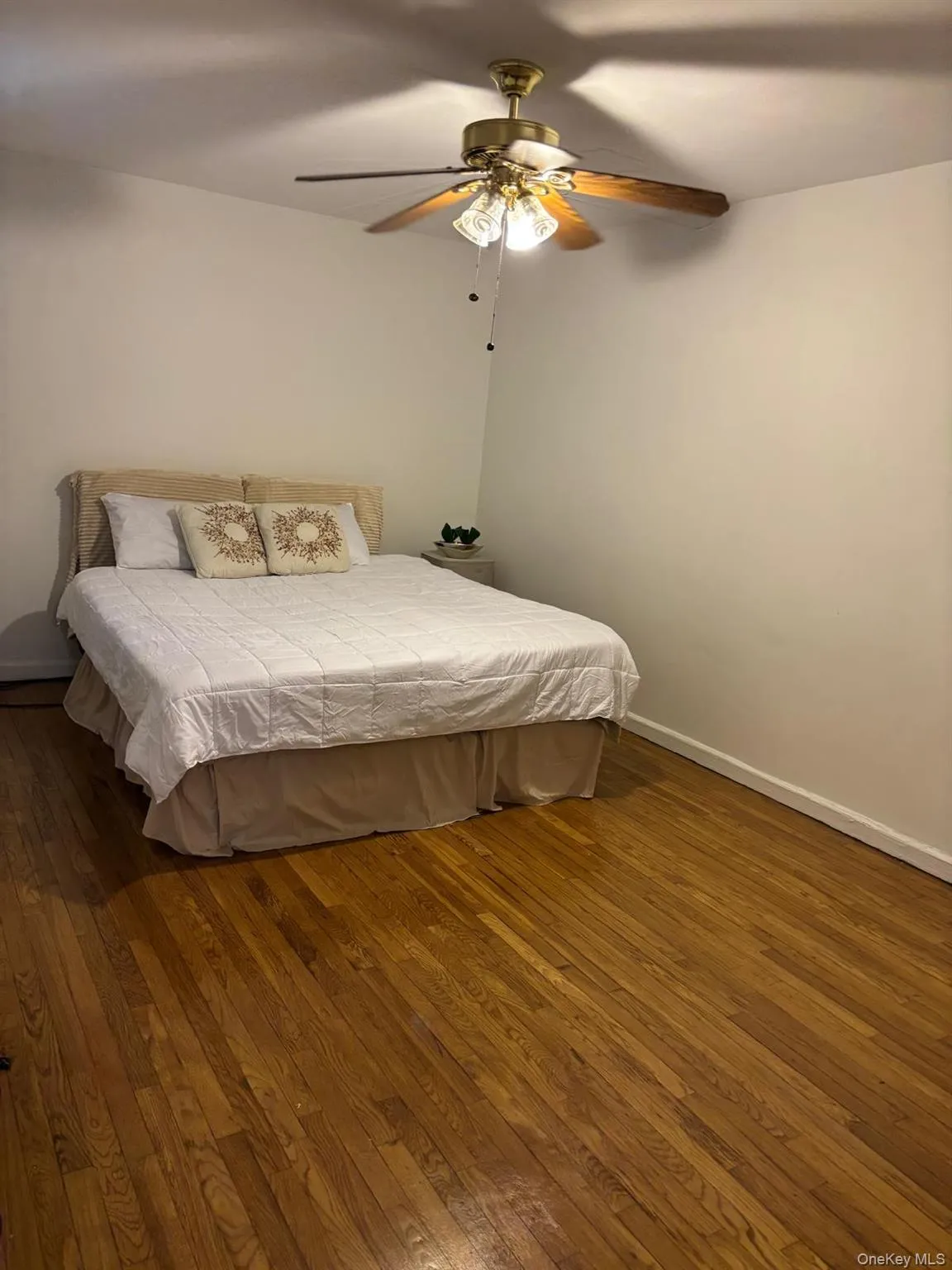 Bedroom featuring hardwood / wood-style flooring and ceiling fan Bedroom featuring hardwood / wood-style flooring and ceiling fan