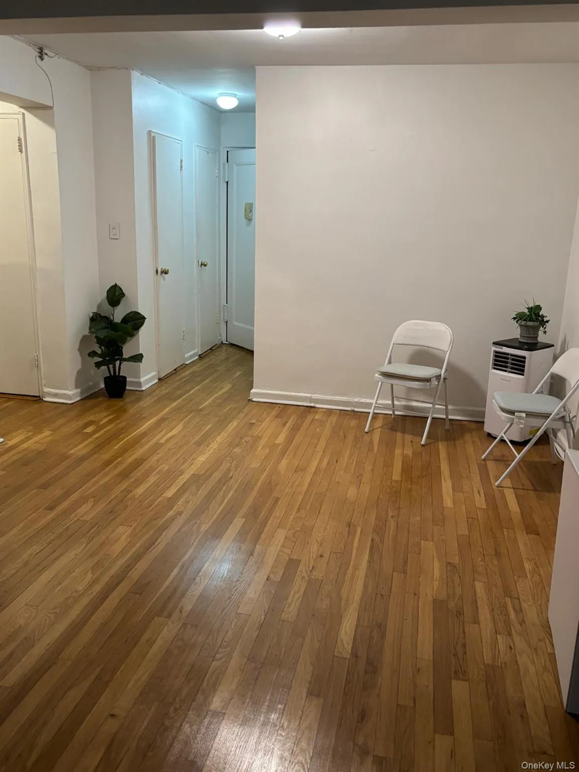 Unfurnished room with light wood finished floors and baseboards Unfurnished room with light wood finished floors and baseboards