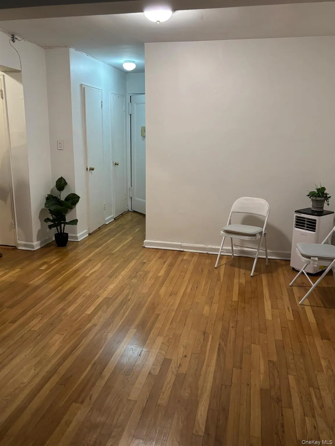 Spare room featuring light wood finished floors and baseboards Spare room featuring light wood finished floors and baseboards