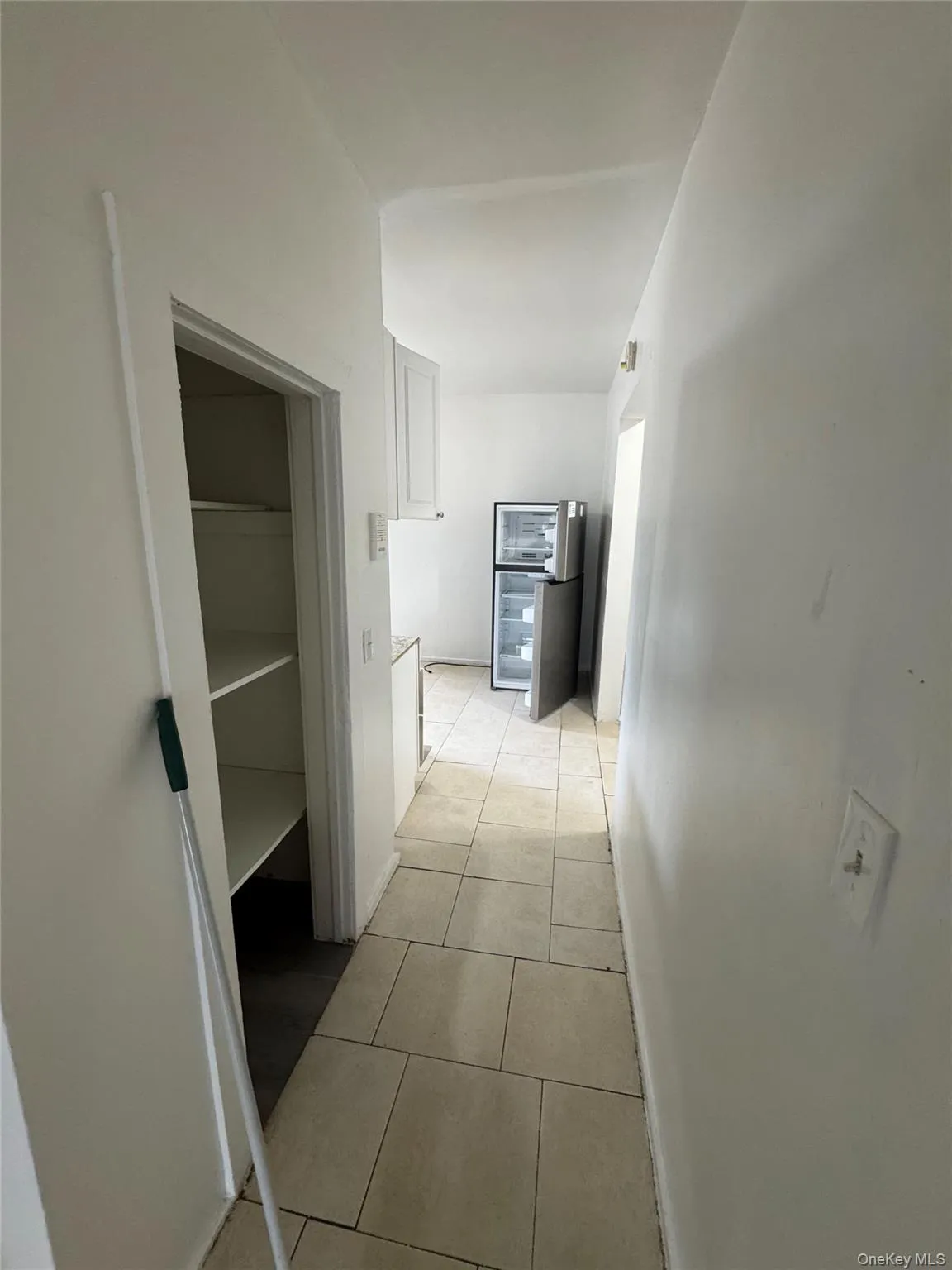 Hallway with light tile patterned flooring Hallway with light tile patterned flooring