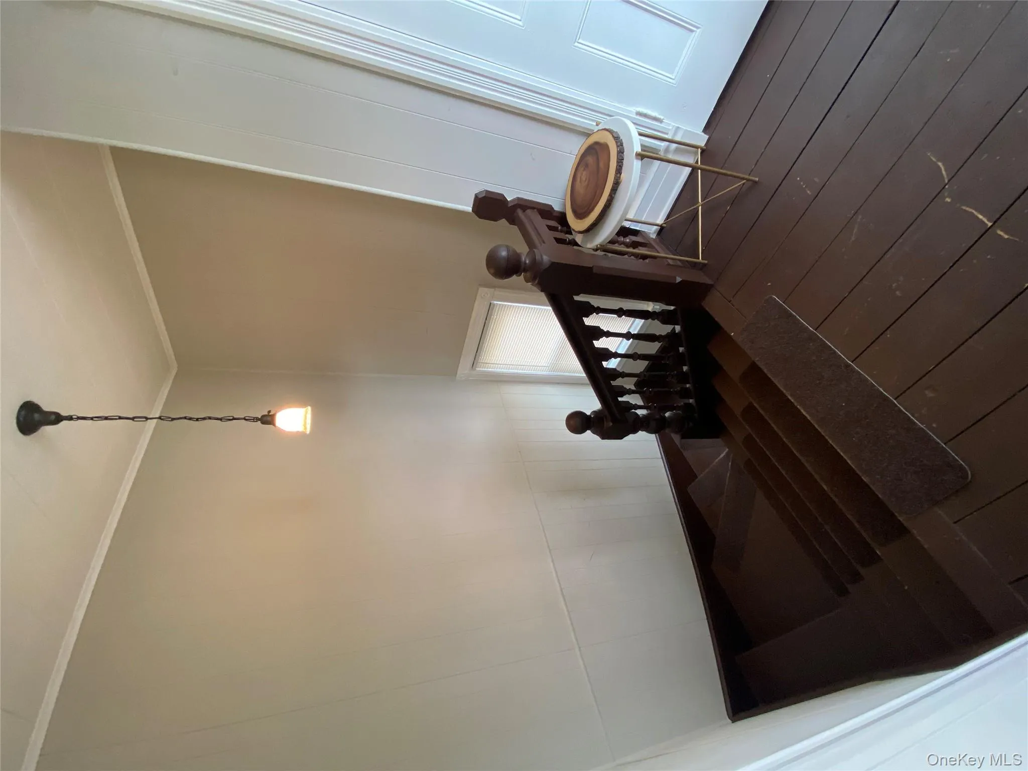 Stairs featuring hardwood / wood-style floors and crown molding Stairs featuring hardwood / wood-style floors and crown molding