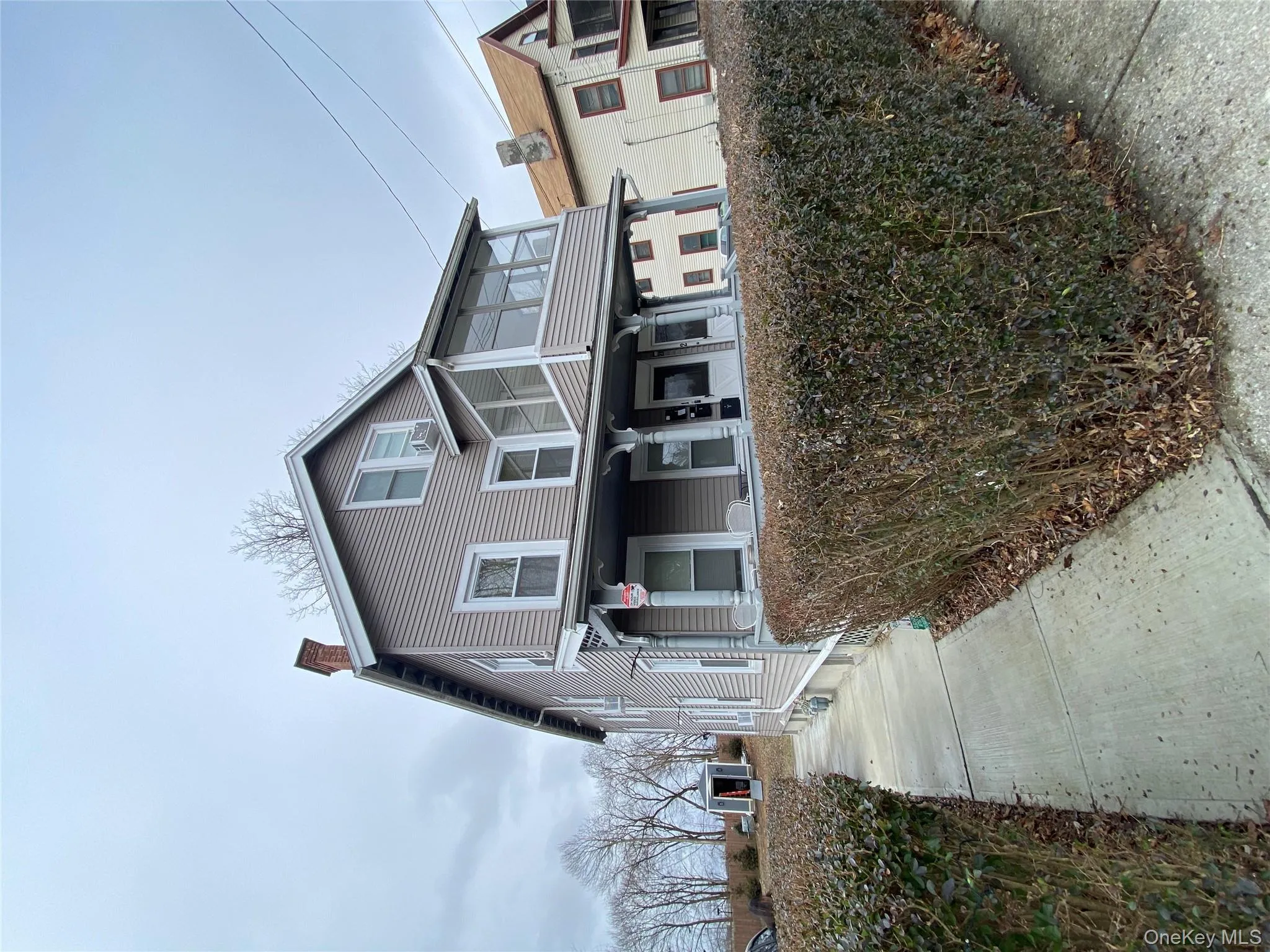 View of front of property with a chimney and a sunroom View of front of property with a chimney and a sunroom