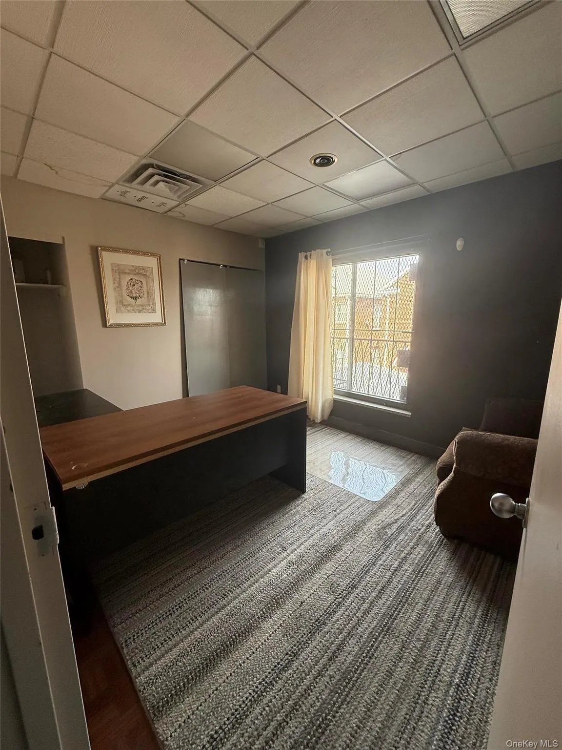 Bedroom featuring a drop ceiling Bedroom featuring a drop ceiling