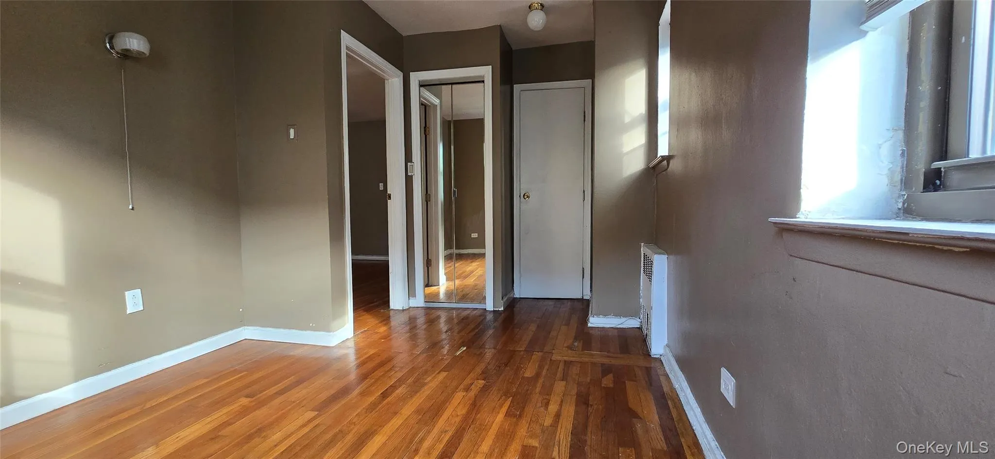 Mirrored closet door and hardwood floor Mirrored closet door and hardwood floor