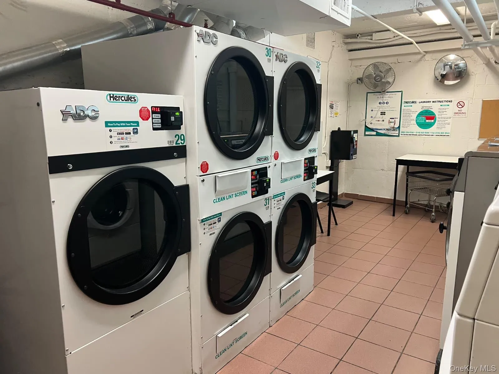 Community laundry with stacked washing machine and dryer Community laundry with stacked washing machine and dryer