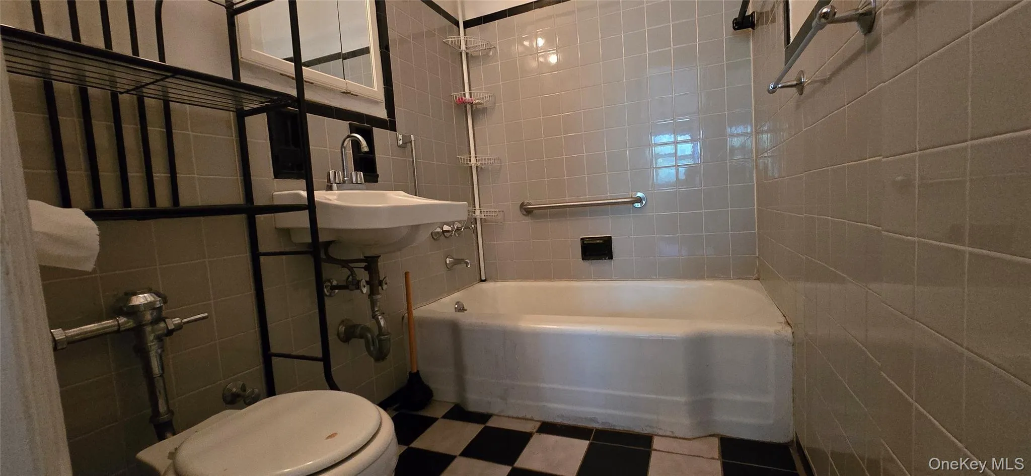 Bathroom featuring tile walls and shower / bath combination Bathroom featuring tile walls and shower / bath combination