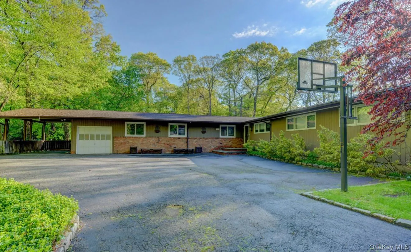 Ranch-style home with brick siding, asphalt driveway, and an attached garage Ranch-style home with brick siding, asphalt driveway, and an attached garage
