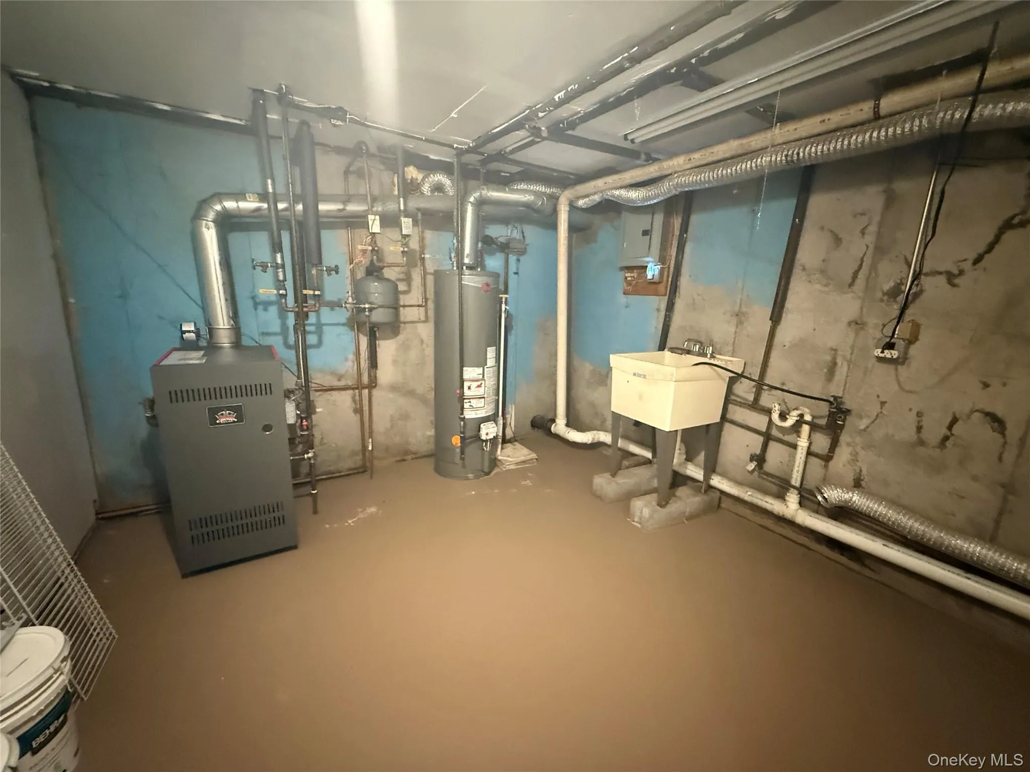 Unfinished below grade area with gas water heater, a heating unit, and electric panel Unfinished below grade area with gas water heater, a heating unit, and electric panel