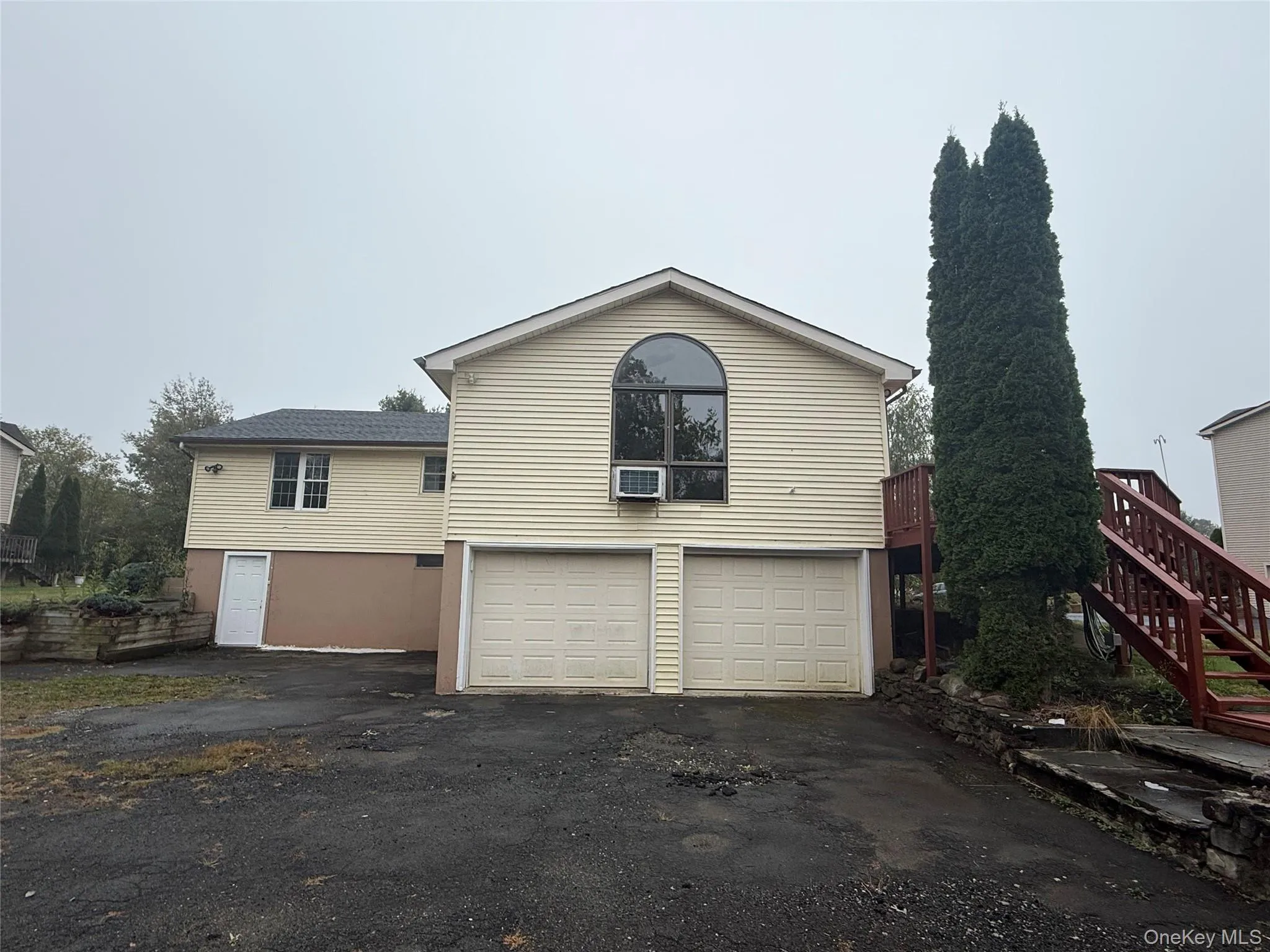View of front of property with driveway, a garage, and stairway View of front of property with driveway, a garage, and stairway