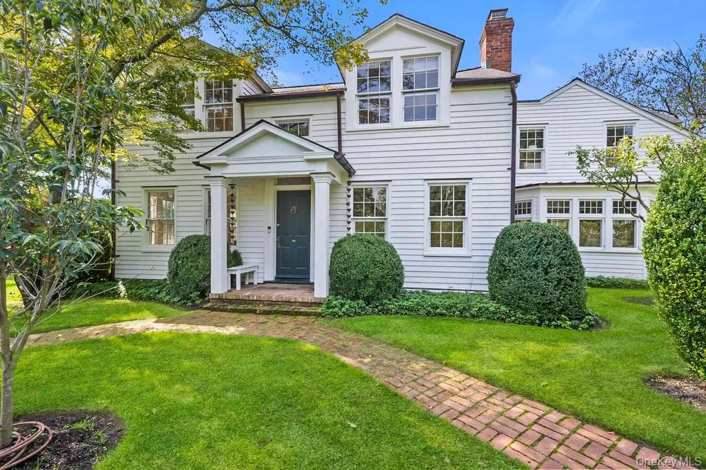 View of front of property with a chimney and a front lawn View of front of property with a chimney and a front lawn