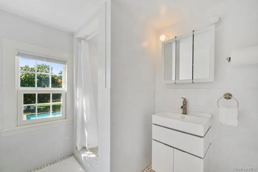 Full bath with vanity, tile walls, and a stall shower Full bath with vanity, tile walls, and a stall shower