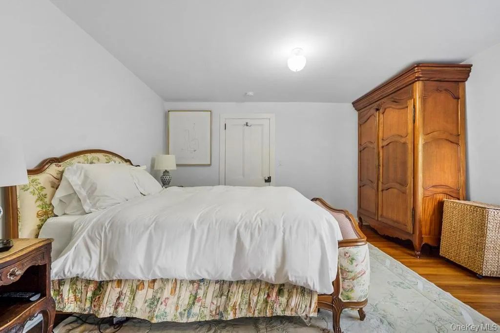 Bedroom with wood finished floors and a closet Bedroom with wood finished floors and a closet