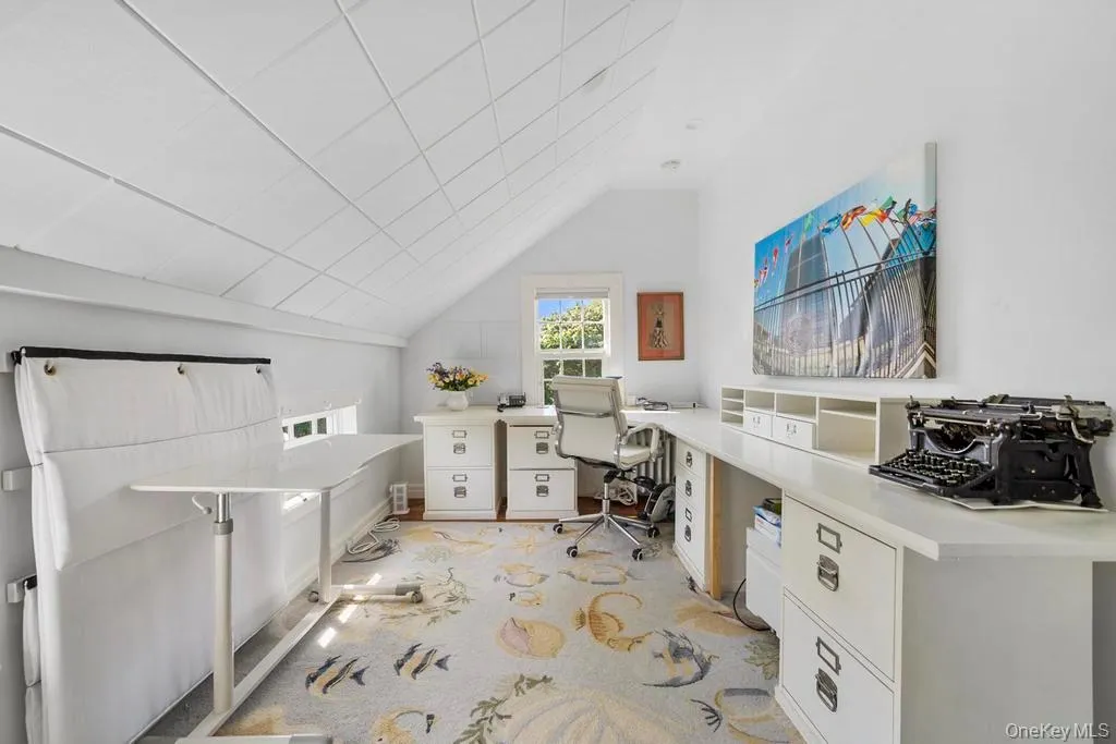 Office featuring light carpet and vaulted ceiling Office featuring light carpet and vaulted ceiling