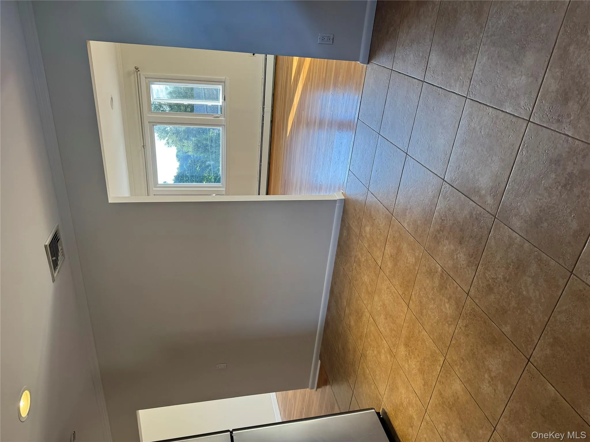Unfurnished room featuring ornamental molding, baseboard heating, and light tile patterned floors Unfurnished room featuring ornamental molding, baseboard heating, and light tile patterned floors